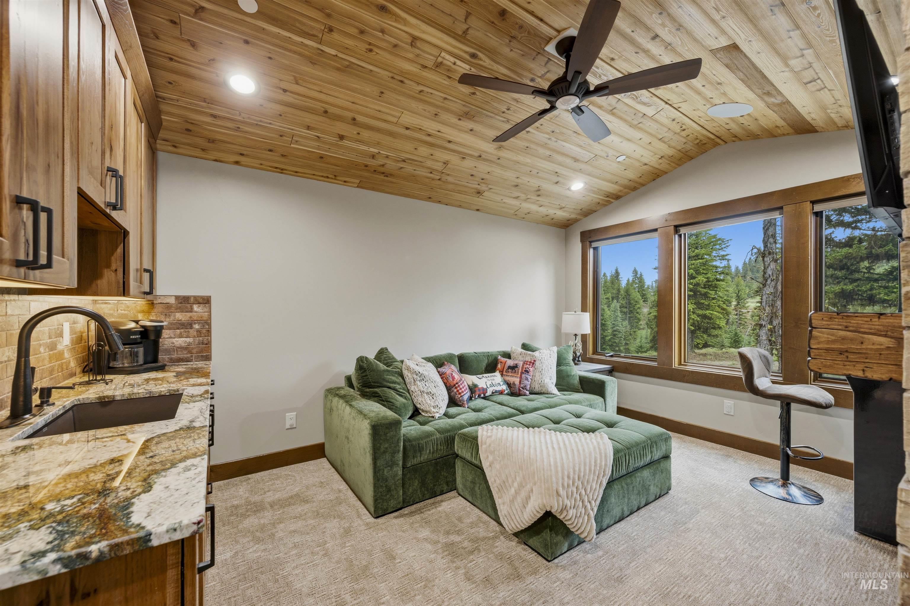 Vaulted wood-paneled ceiling with recessed lighting and ceiling fan - Second Level with Kitchenette
