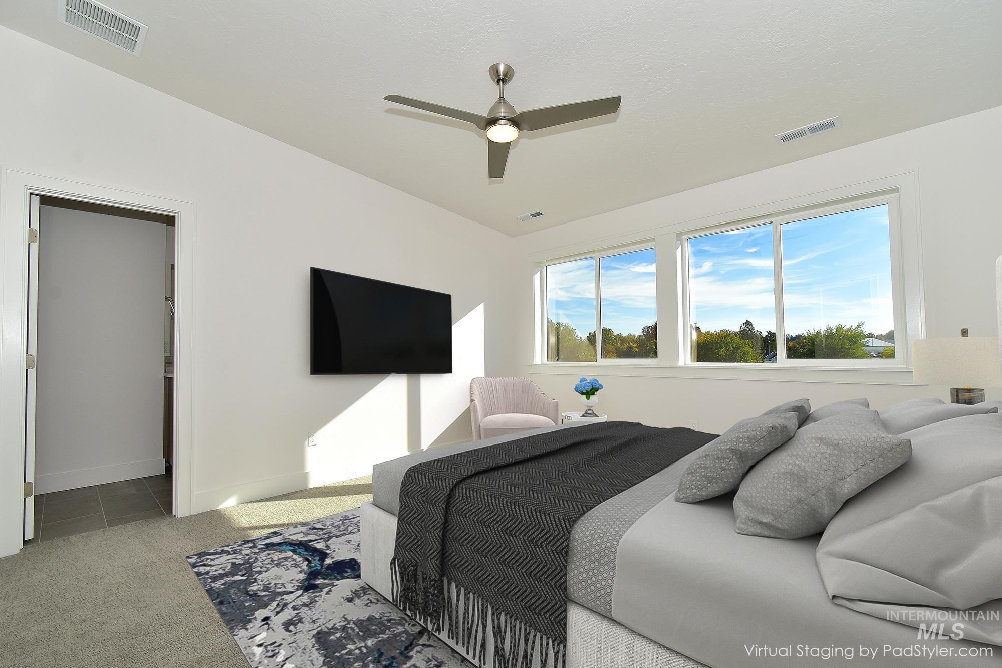 Bedroom with light carpet, a ceiling fan, and light tile patterned floors