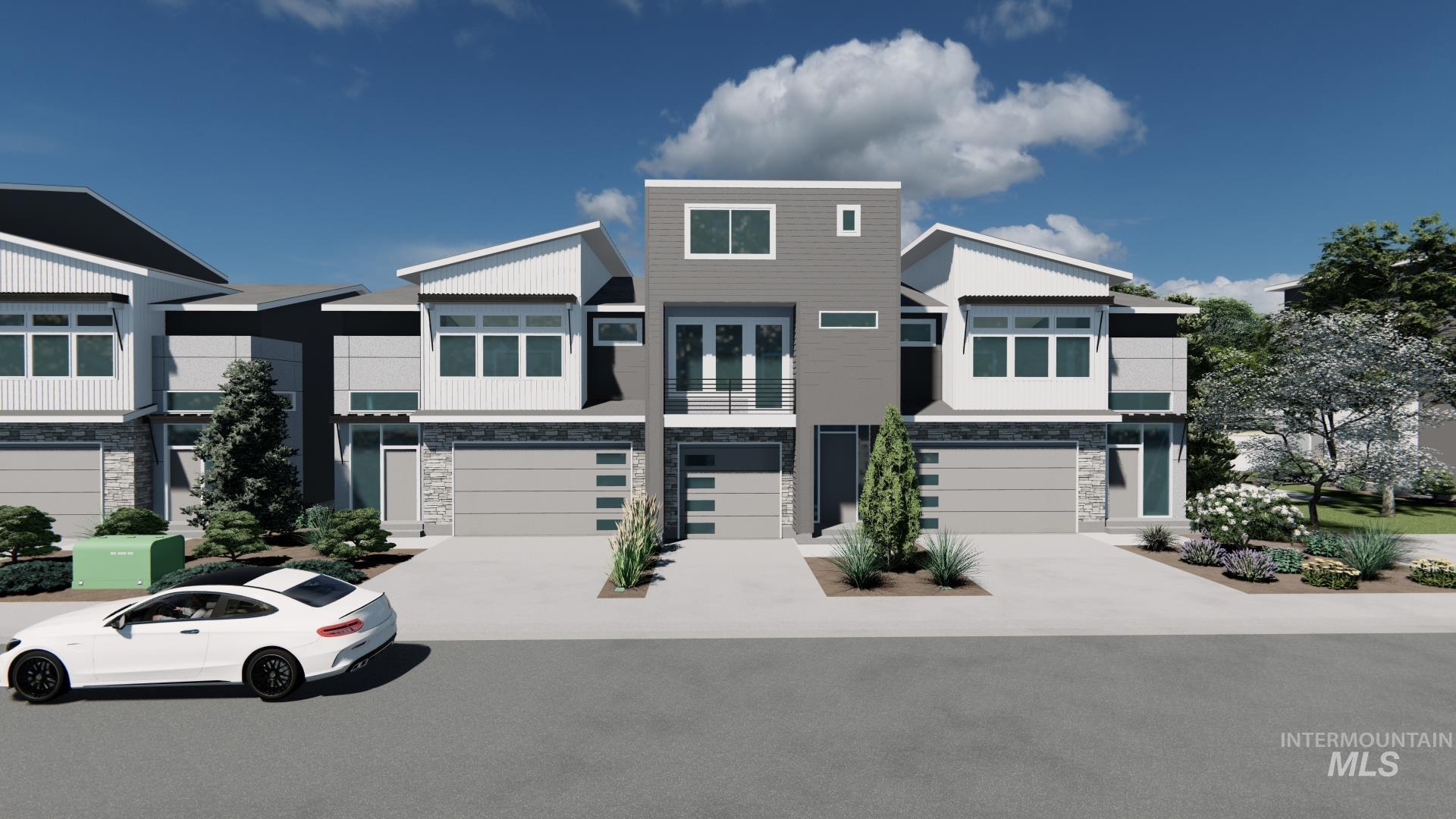 Contemporary house featuring stone siding, driveway, and a tandem garage