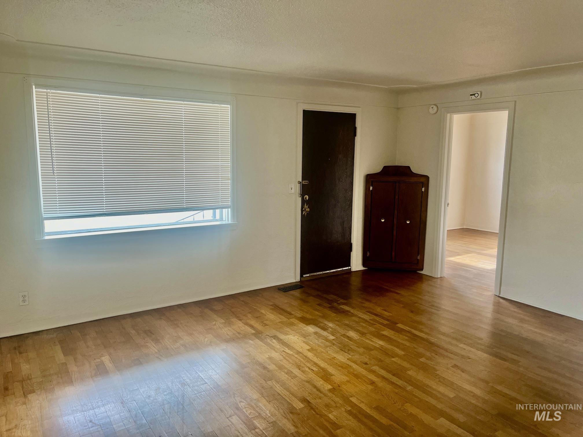 Unfurnished room featuring wood-type flooring