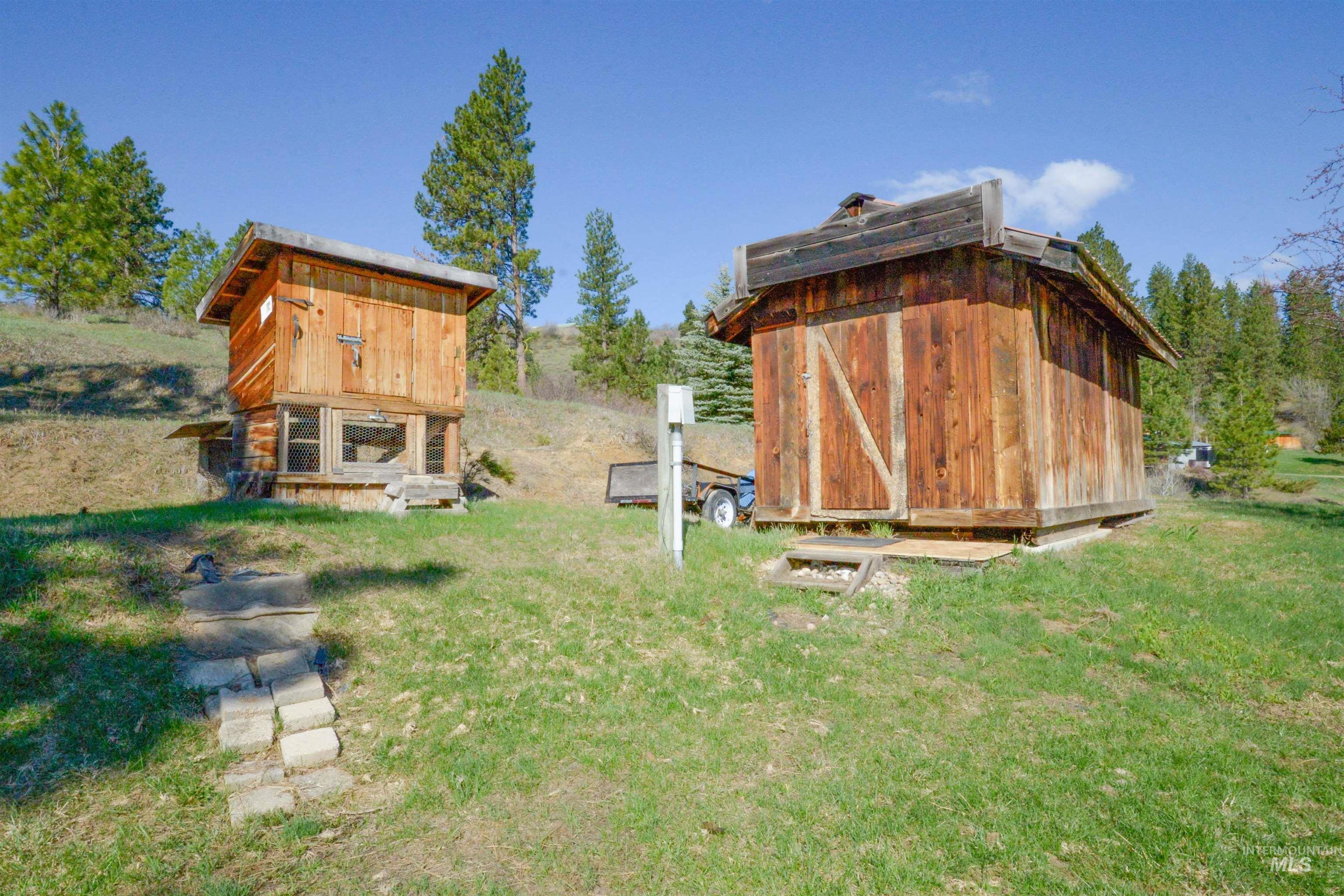 View of grassy yard with a storage unit