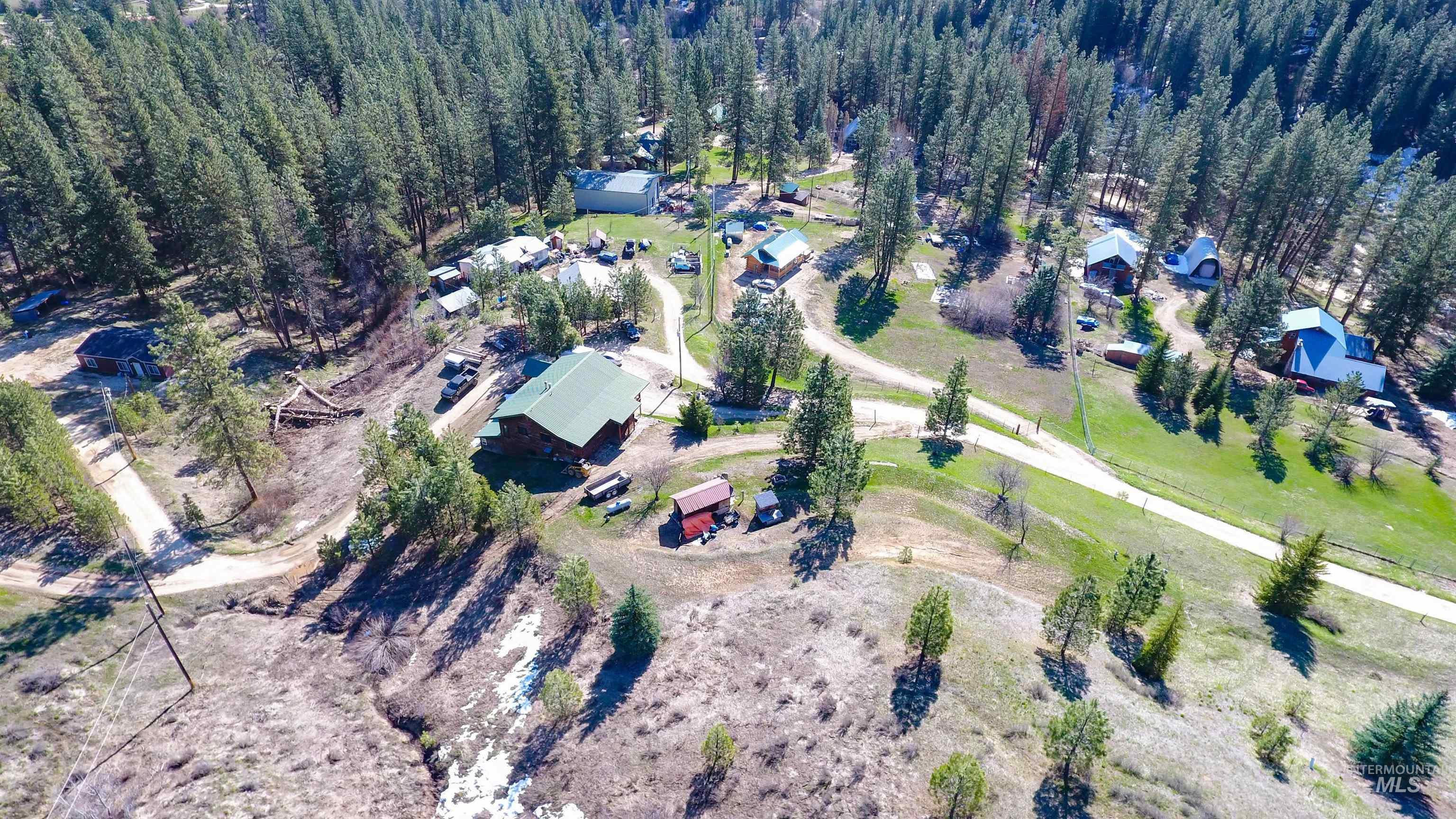 Aerial view of property's location with a heavily wooded area