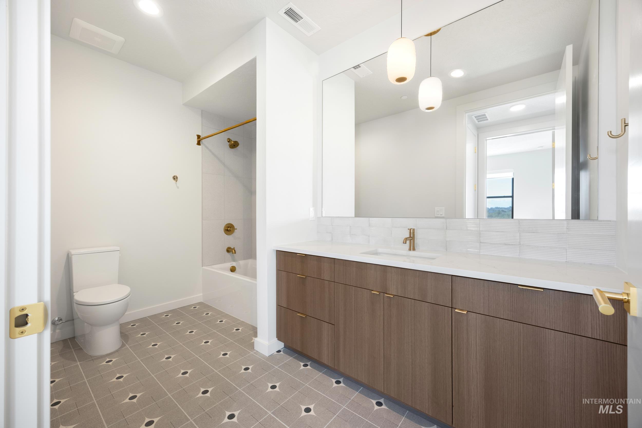 Bathroom with shower / bath combination, vanity, recessed lighting, light tile patterned flooring, and backsplash