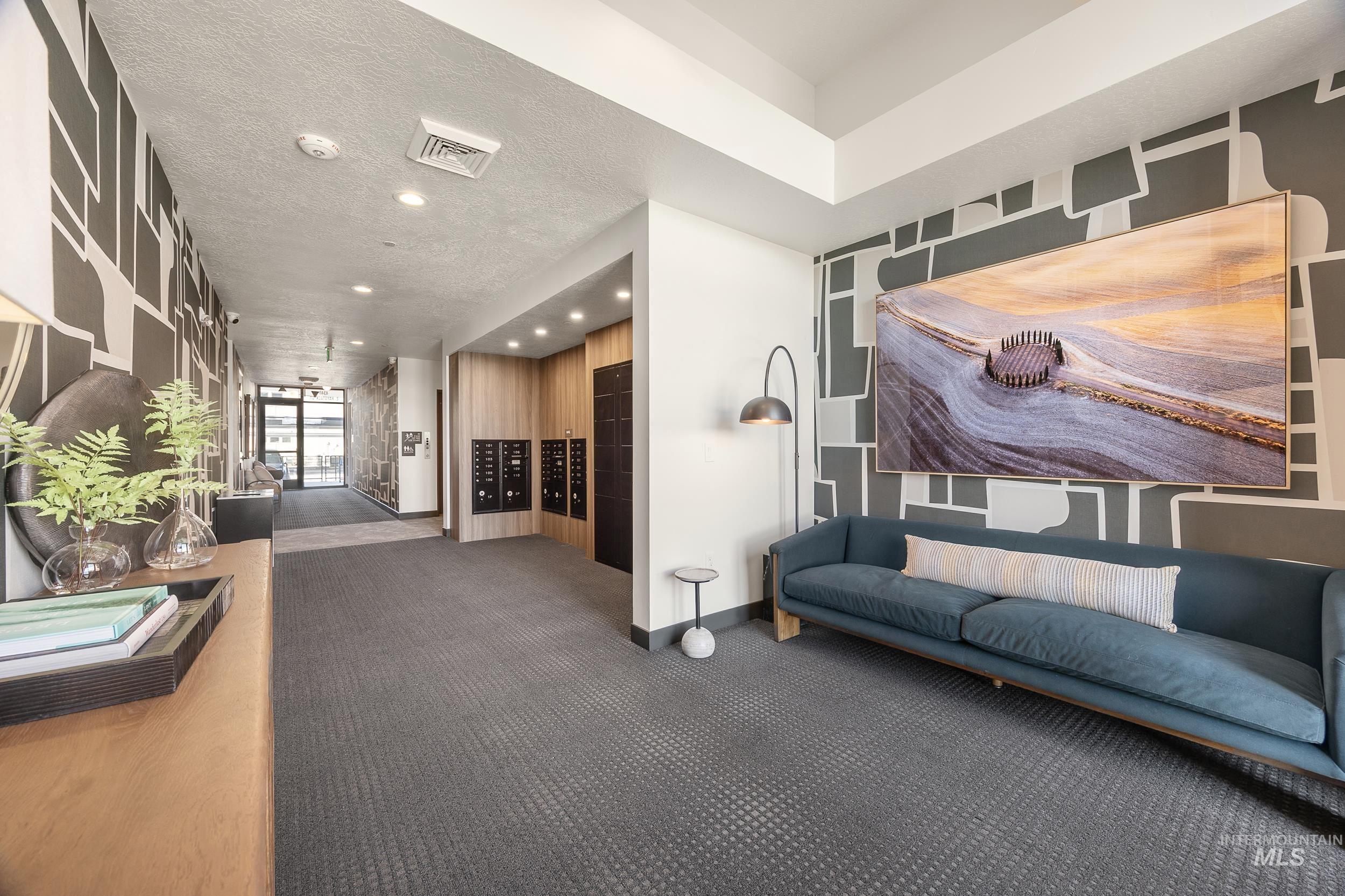 Building lobby featuring a textured ceiling and recessed lighting