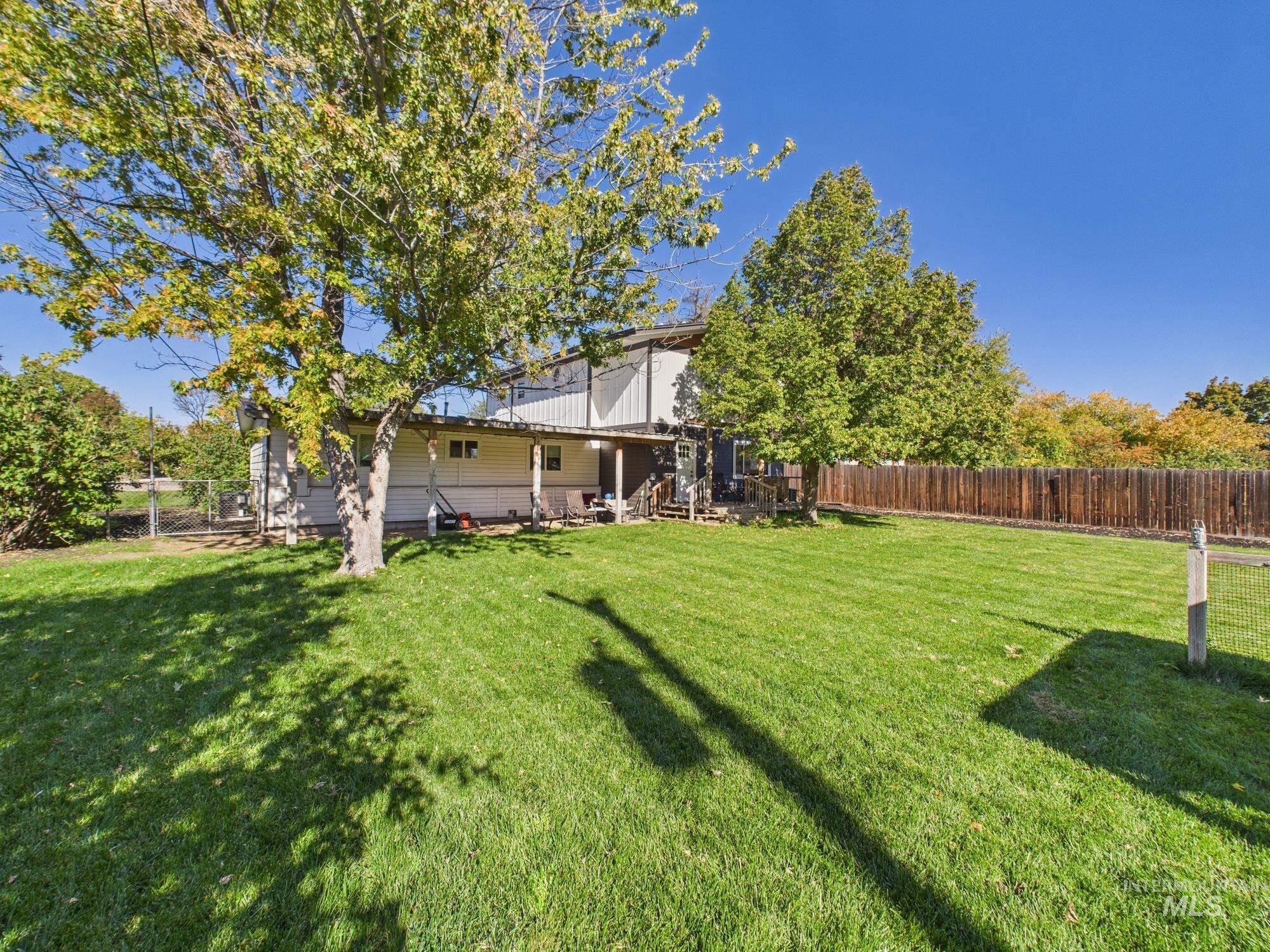 Back of house featuring a fenced backyard, stairway, and a patio area