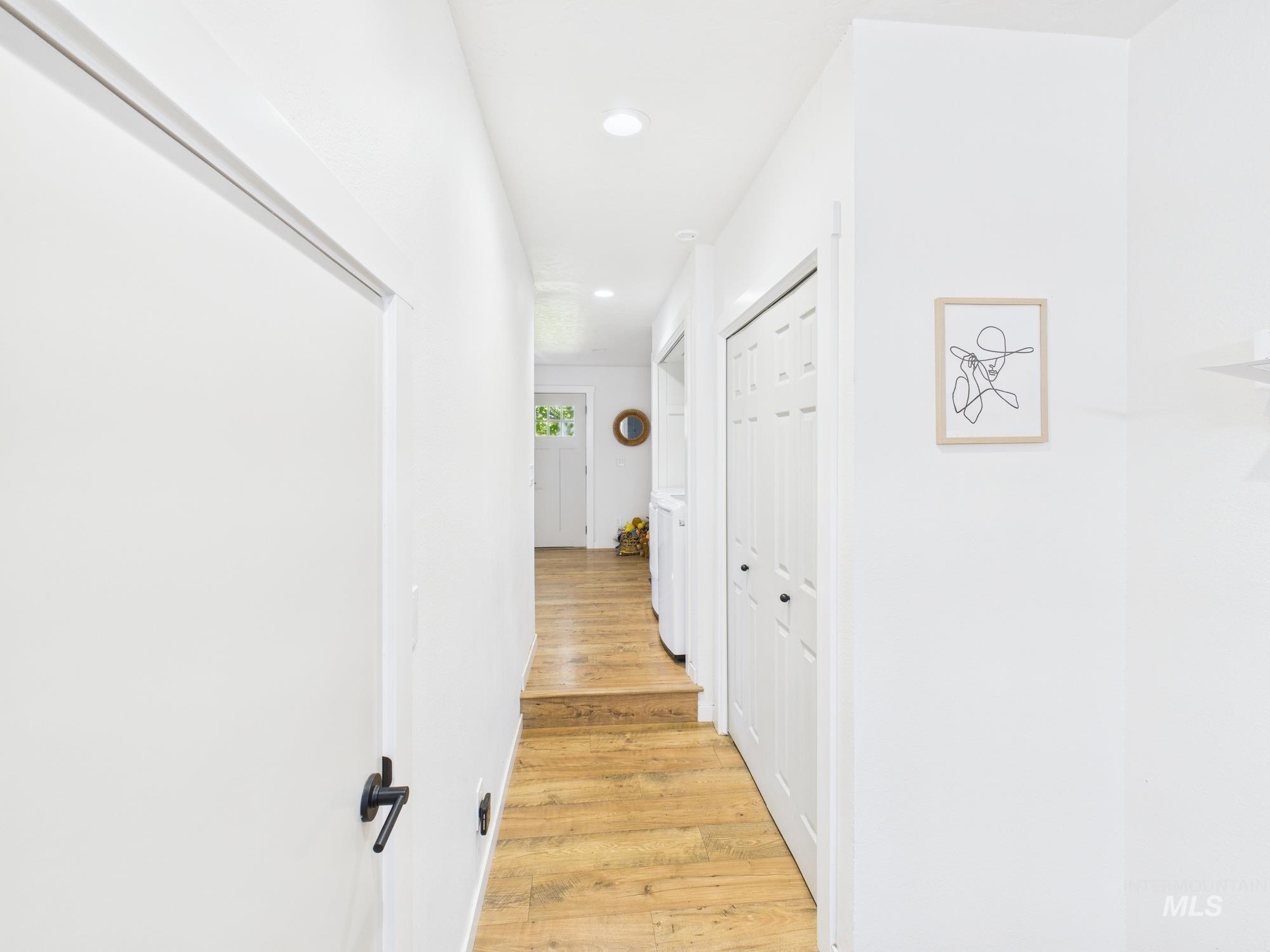 Hall with recessed lighting and light wood-type flooring