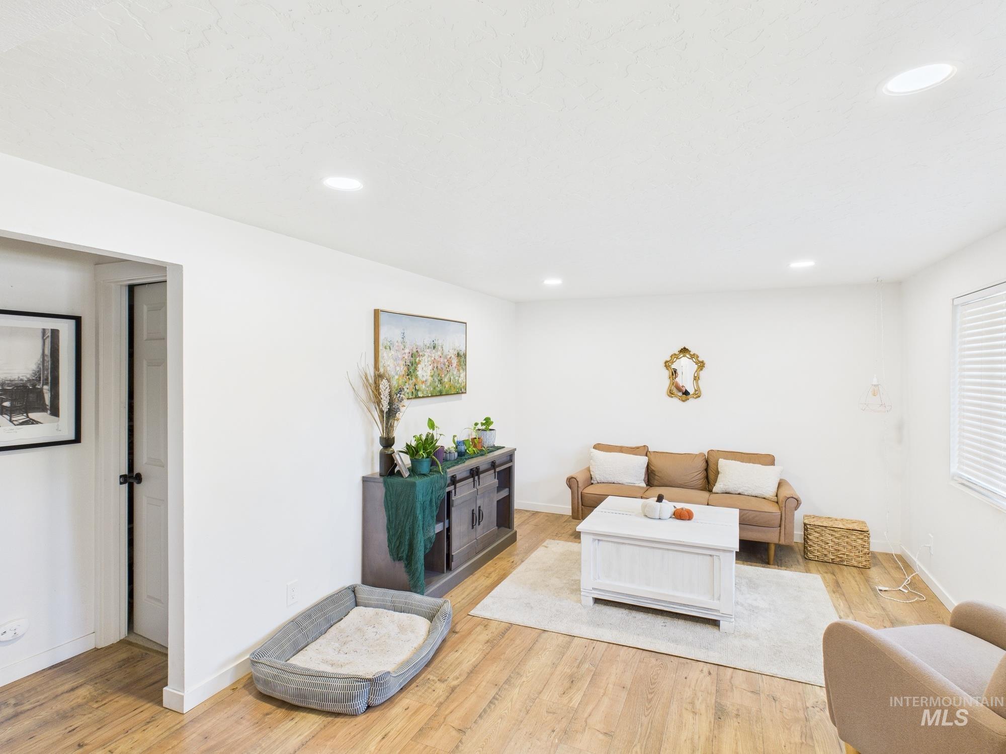 Living room with wood finished floors and recessed lighting