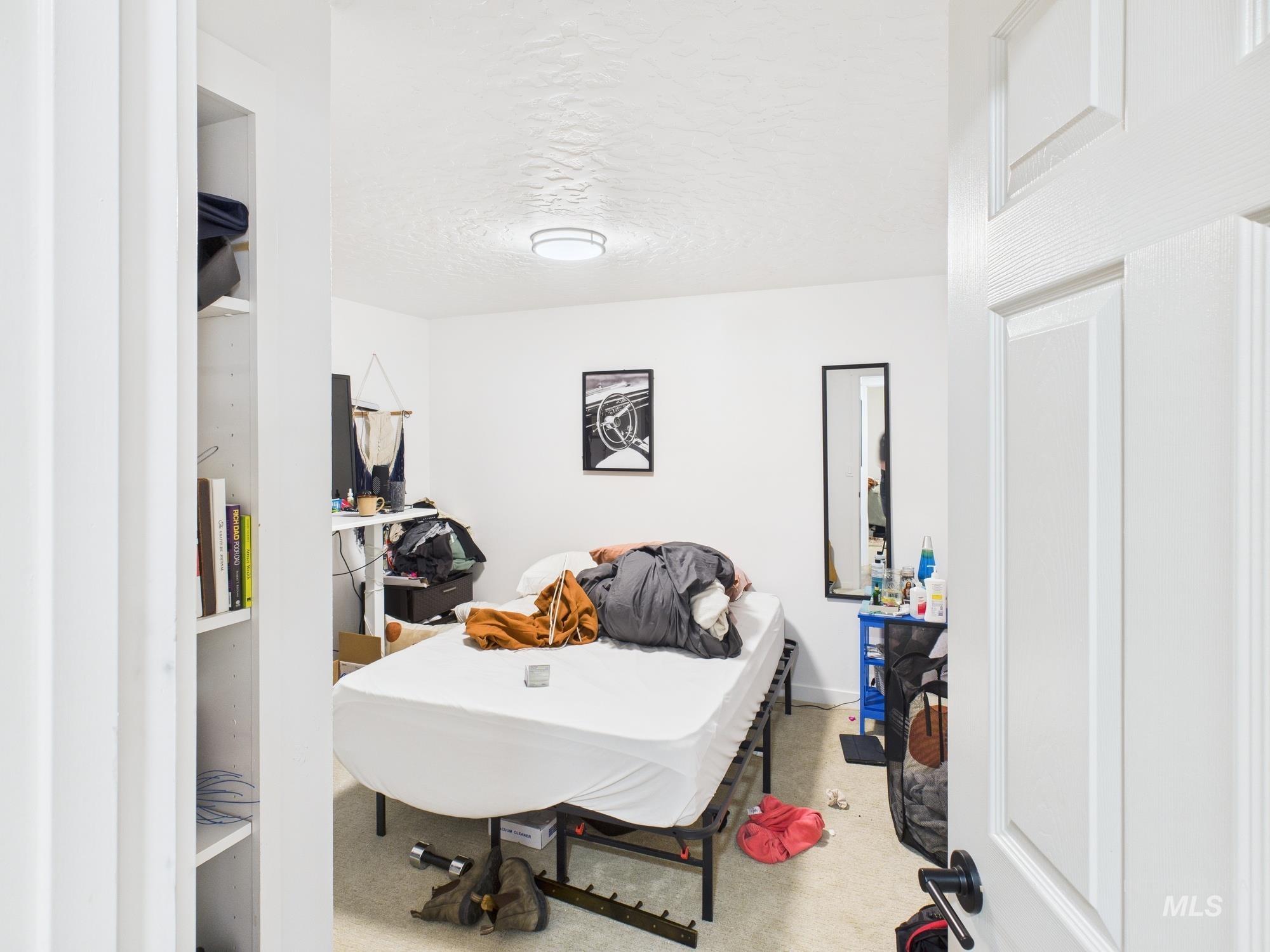 Bedroom with carpet flooring and a textured ceiling