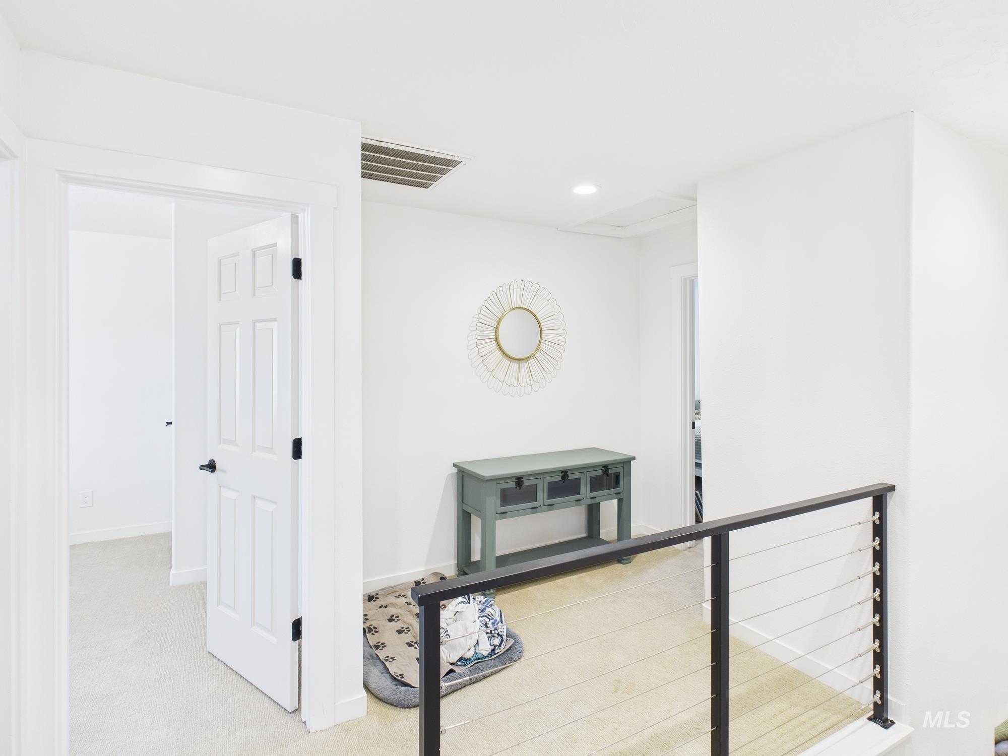 Corridor with light carpet and recessed lighting