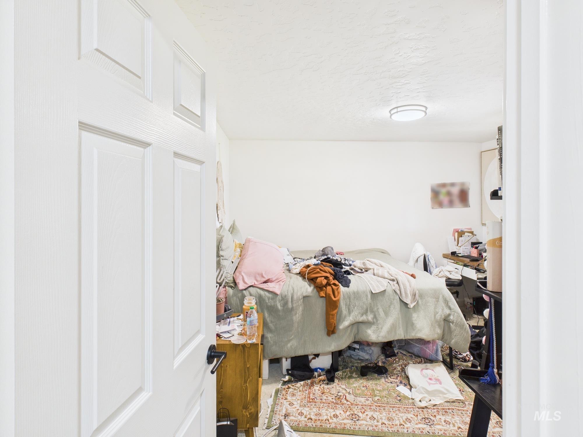 Bedroom with a textured ceiling