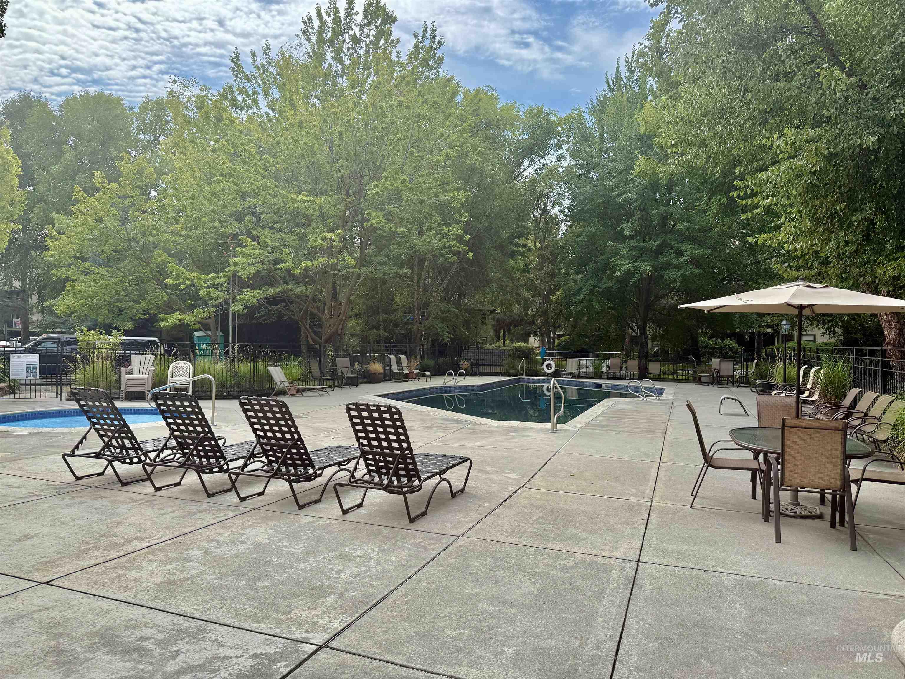 Community pool with a patio
