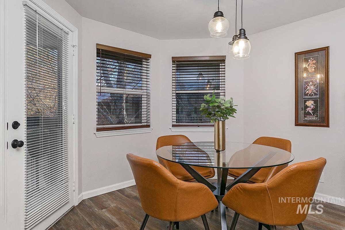Dining space with dark wood finished floors and baseboards