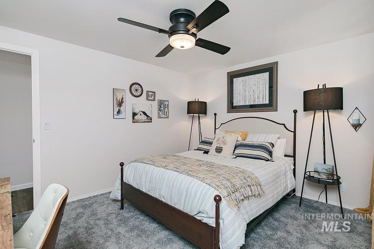 Bedroom featuring ceiling fan and carpet flooring