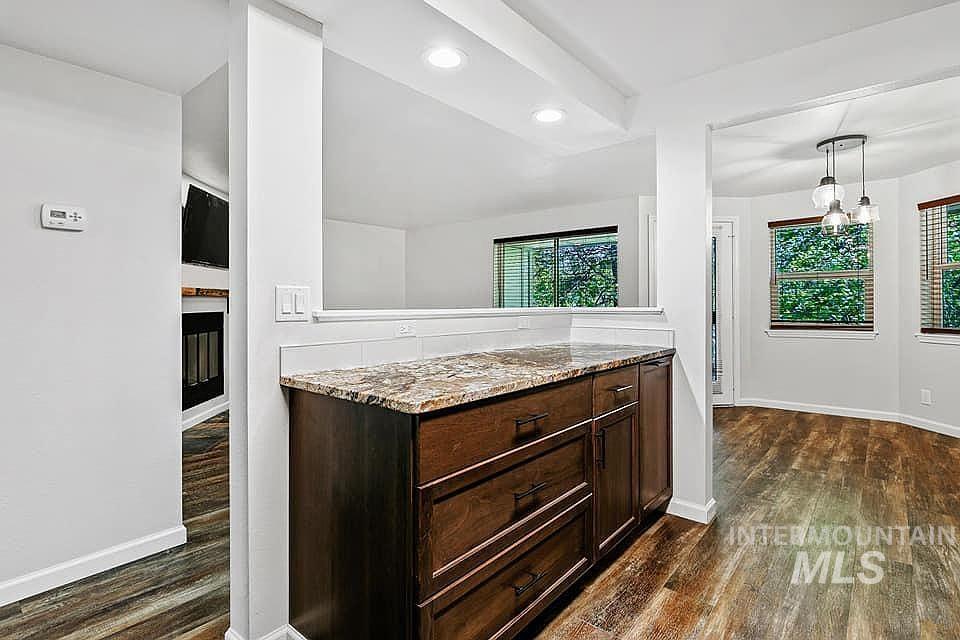 Bathroom with dark wood-style flooring, recessed lighting, and a chandelier