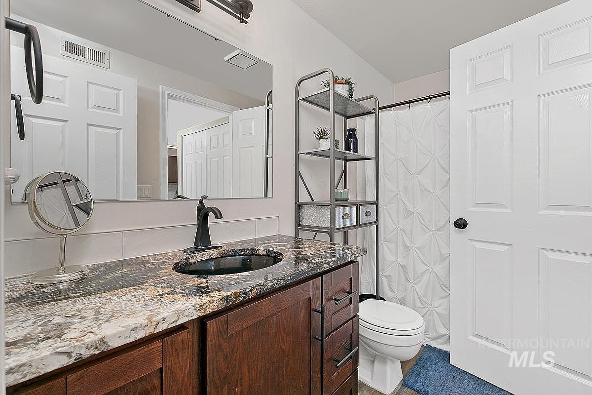 Bathroom featuring vanity and curtained shower