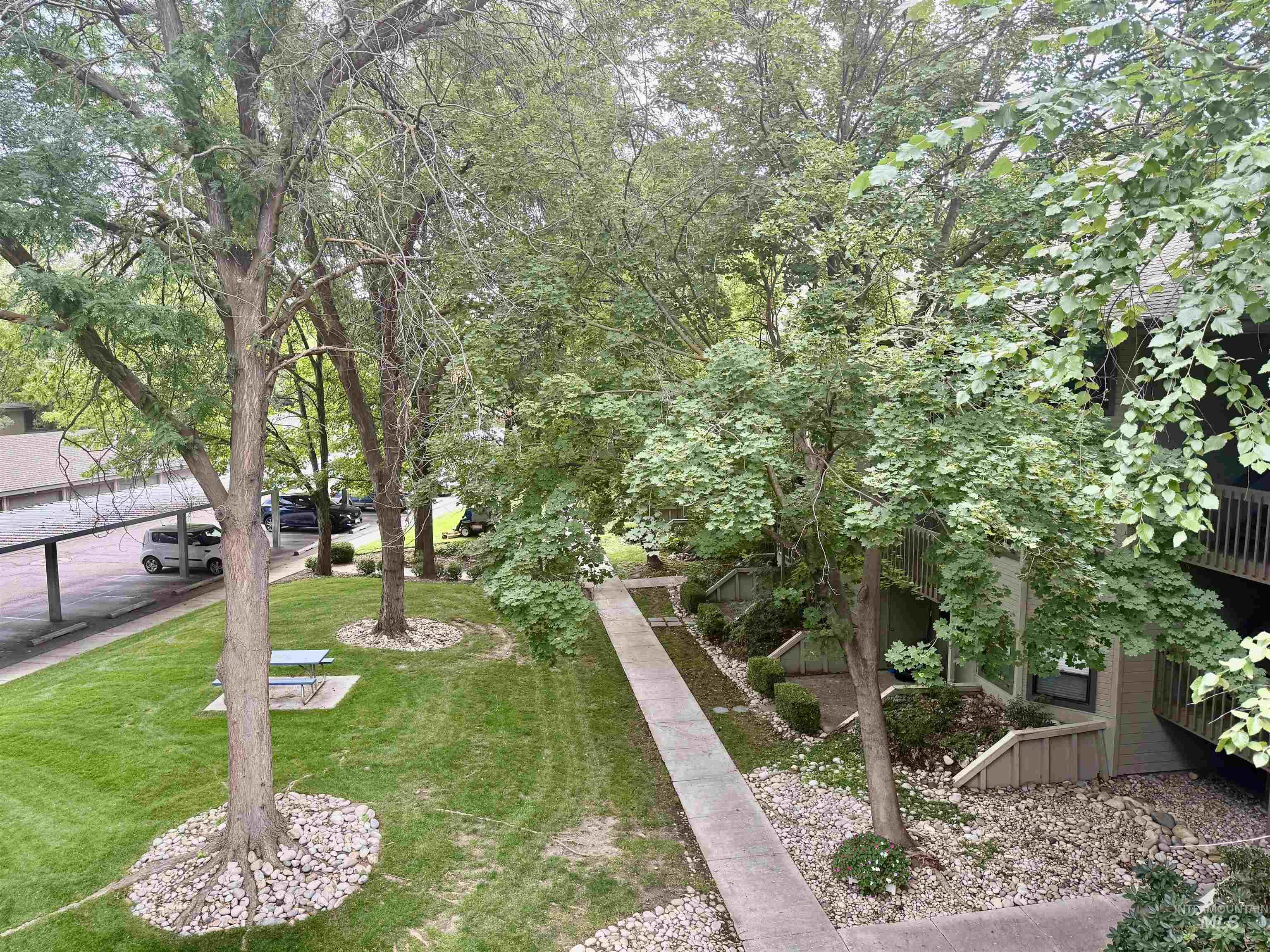 View of property's community with a lawn