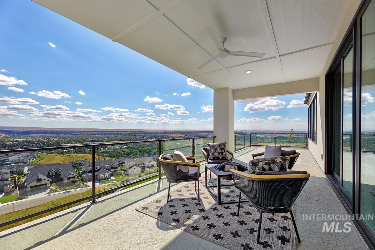 Balcony with a ceiling fan, an outdoor hangout area, and a residential view