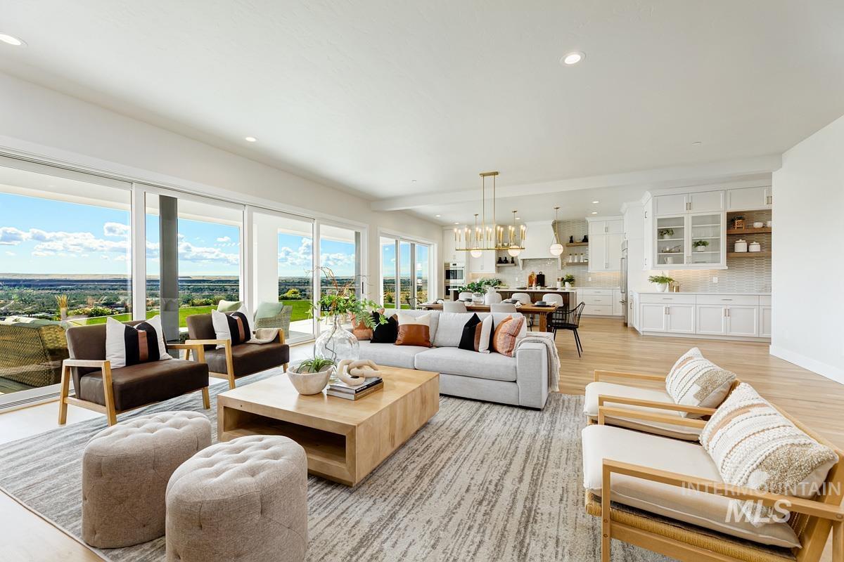 Living area featuring recessed lighting, light wood-style floors, and a chandelier