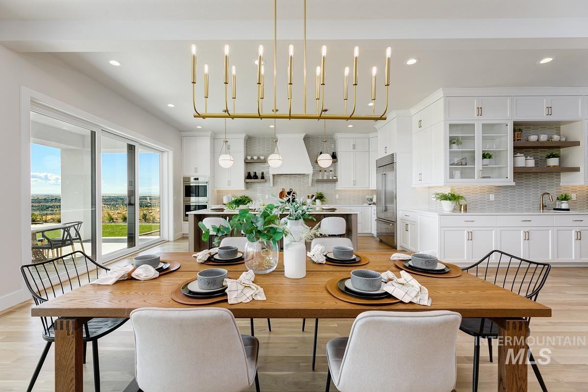 Dining room with light wood-style flooring and recessed lighting