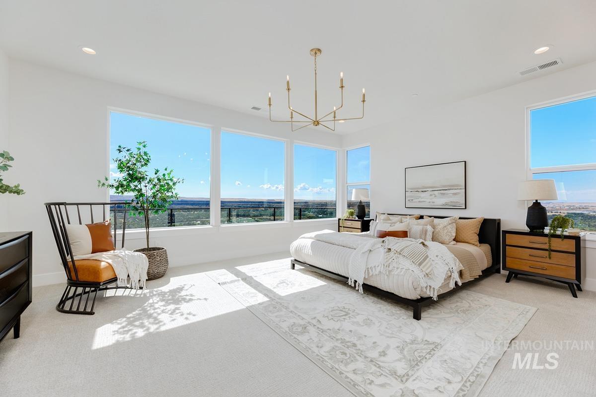 Bedroom featuring light carpet, recessed lighting, and a chandelier