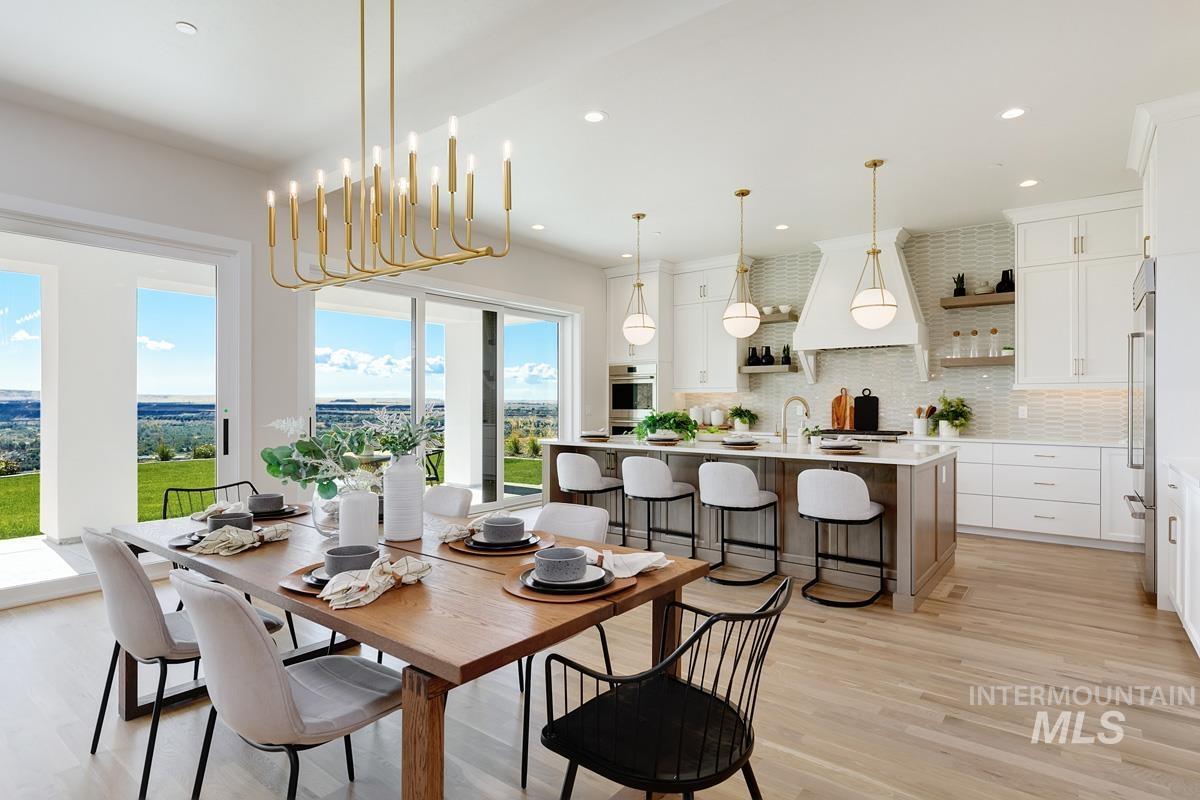 Dining room with light wood-style flooring, recessed lighting, and a chandelier