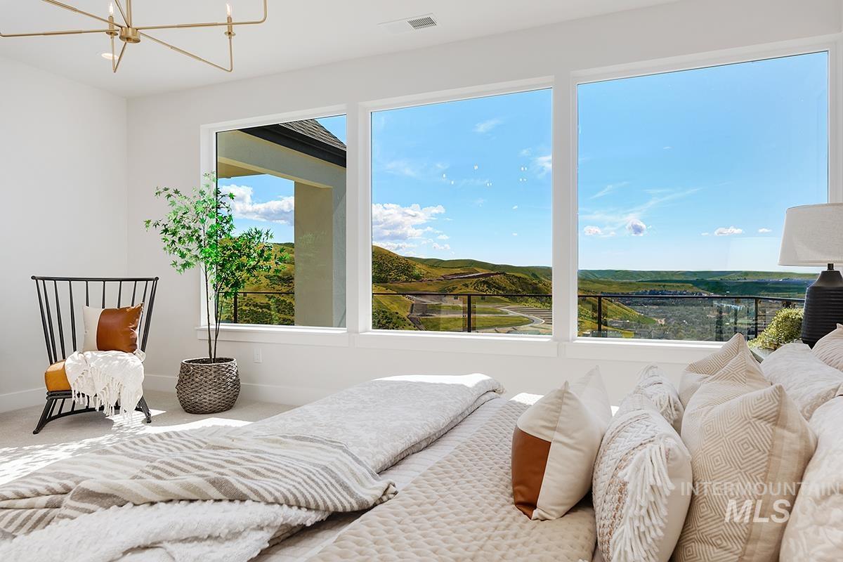 Bedroom featuring a chandelier and carpet flooring