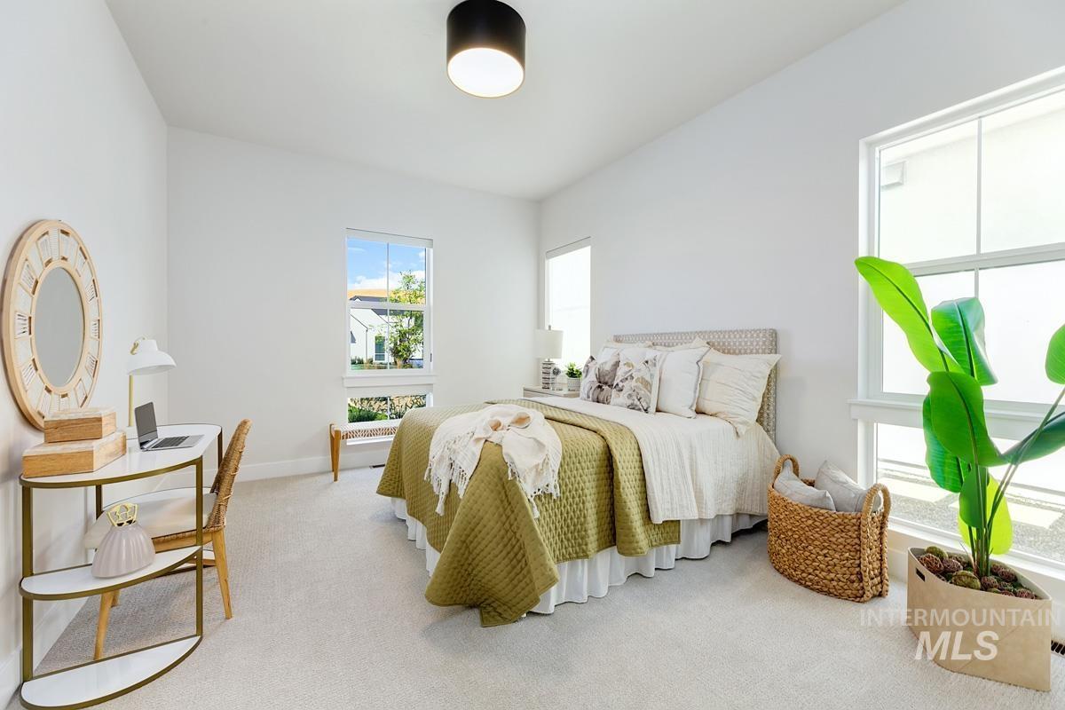 Carpeted bedroom featuring baseboards