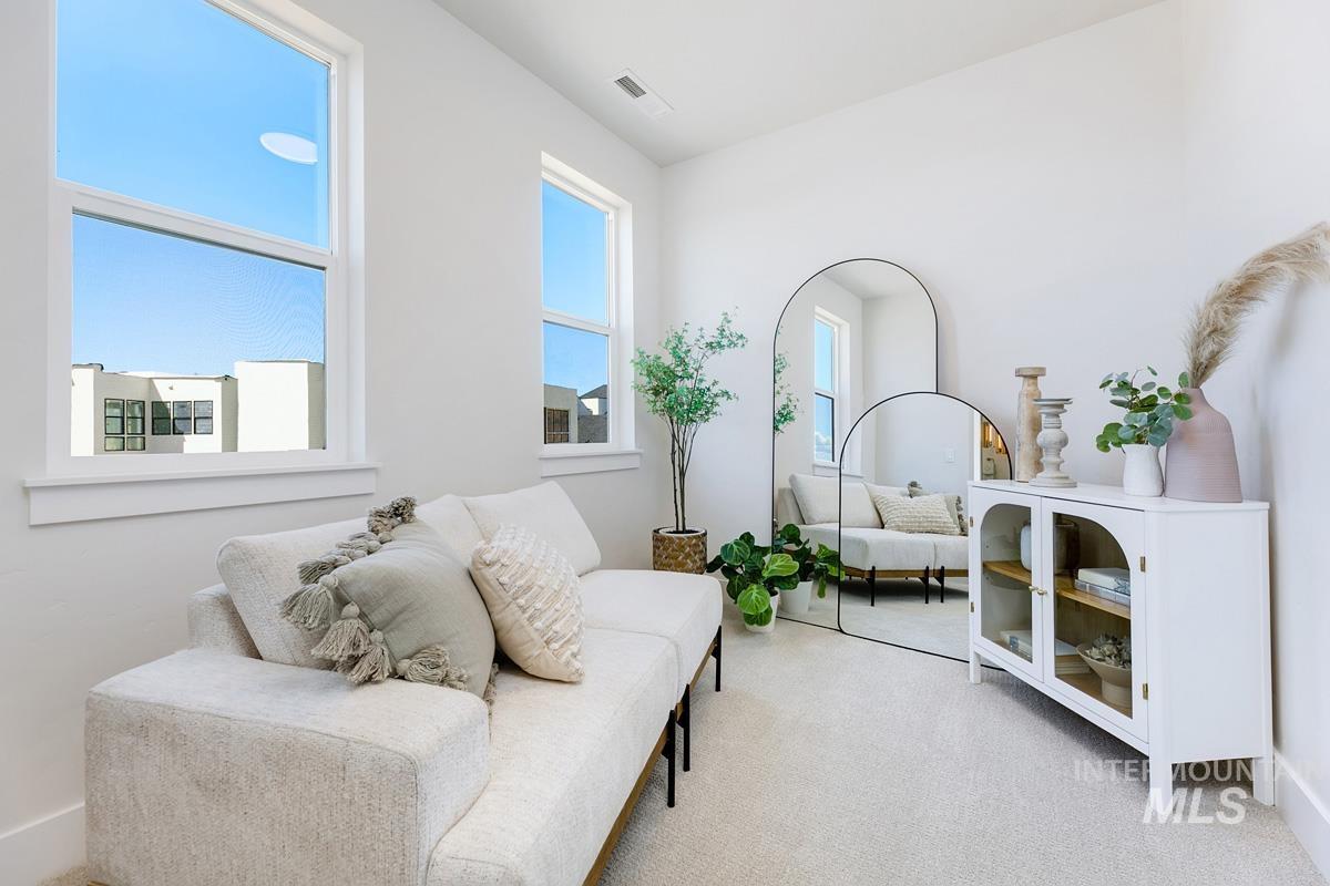 Sitting room featuring light carpet