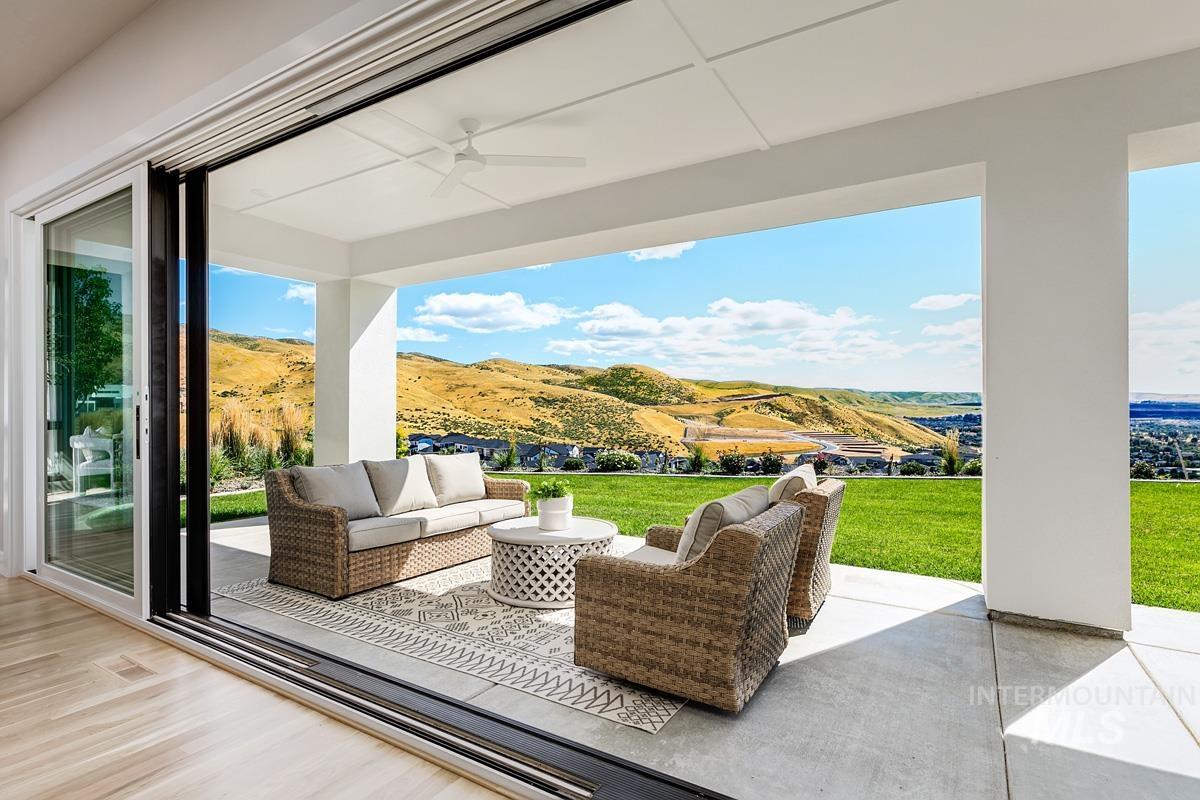 View of patio / terrace featuring an outdoor living space, a ceiling fan, and a mountain view