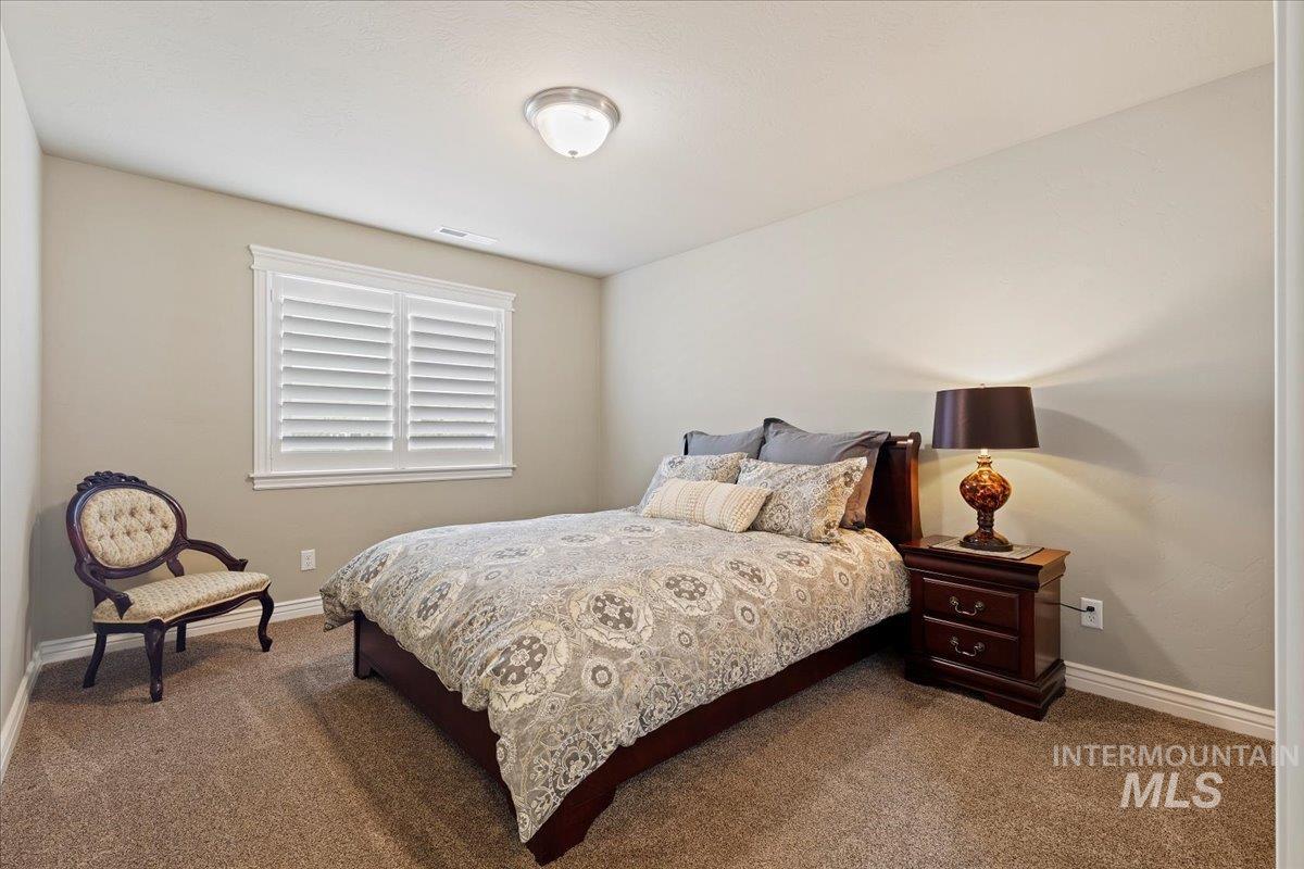 Carpeted bedroom featuring baseboards