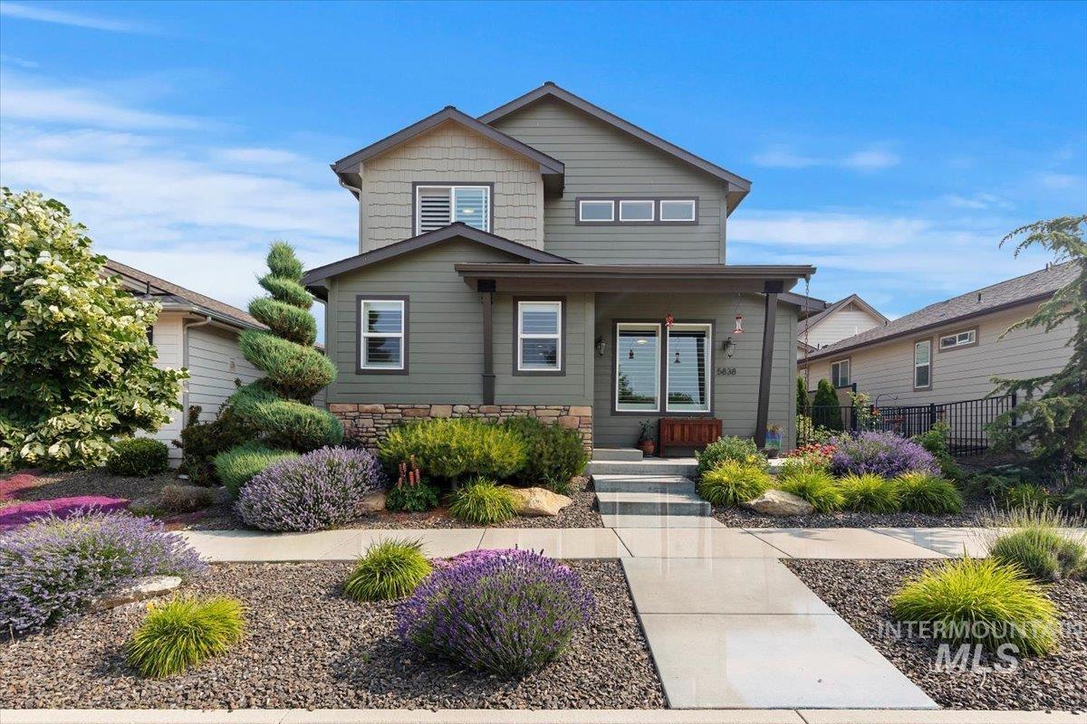 View of front of home with covered porch and stone siding