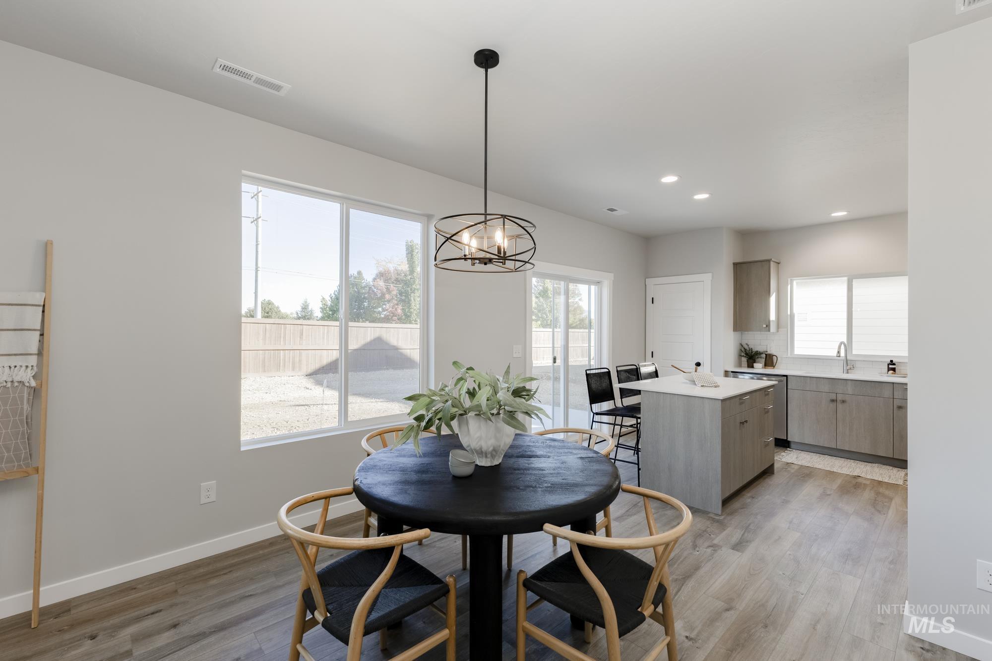 Dining room featuring light wood-style floors, a chandelier, and recessed lighting