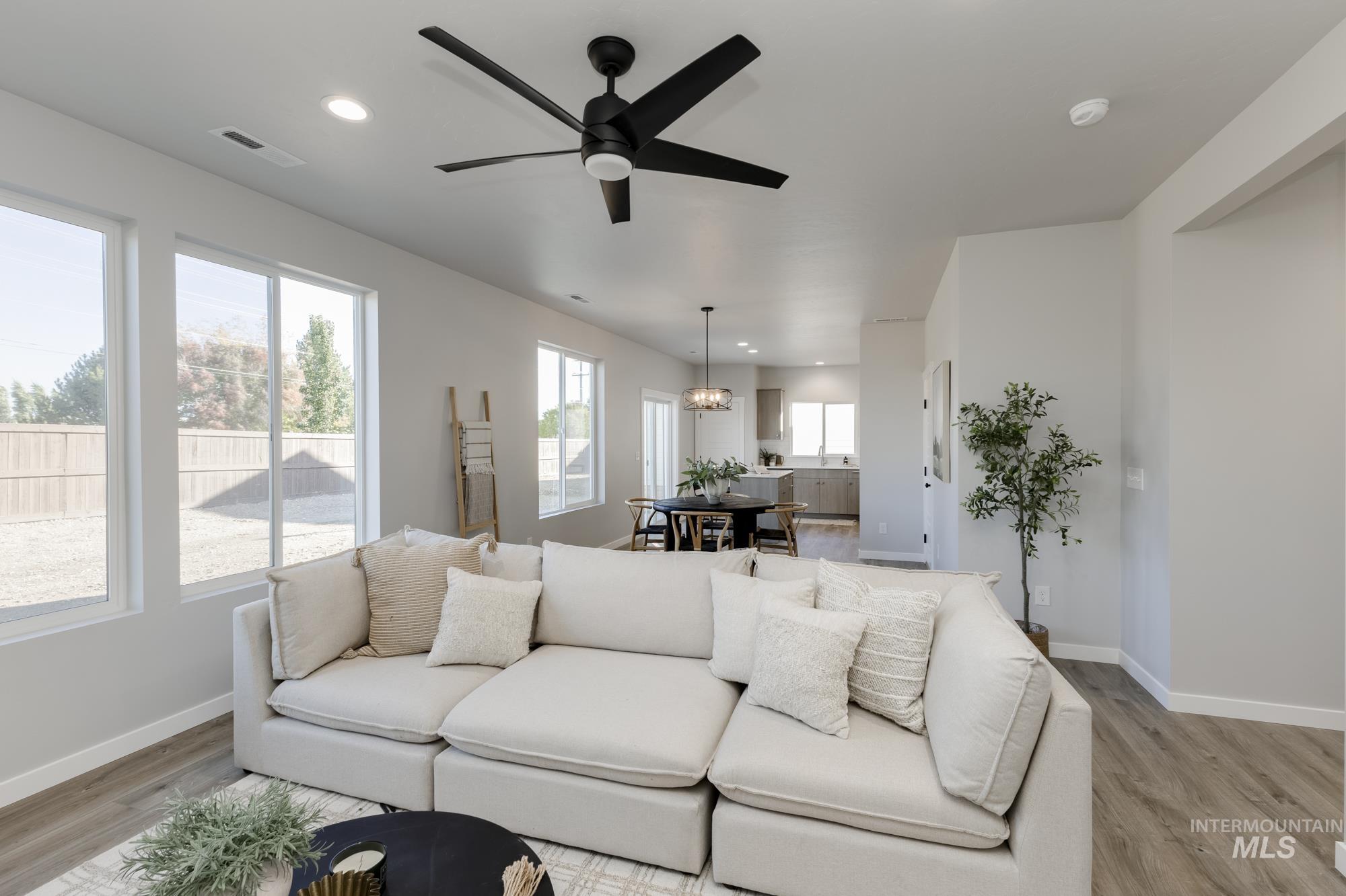 Living room with recessed lighting, ceiling fan, and light wood-style floors