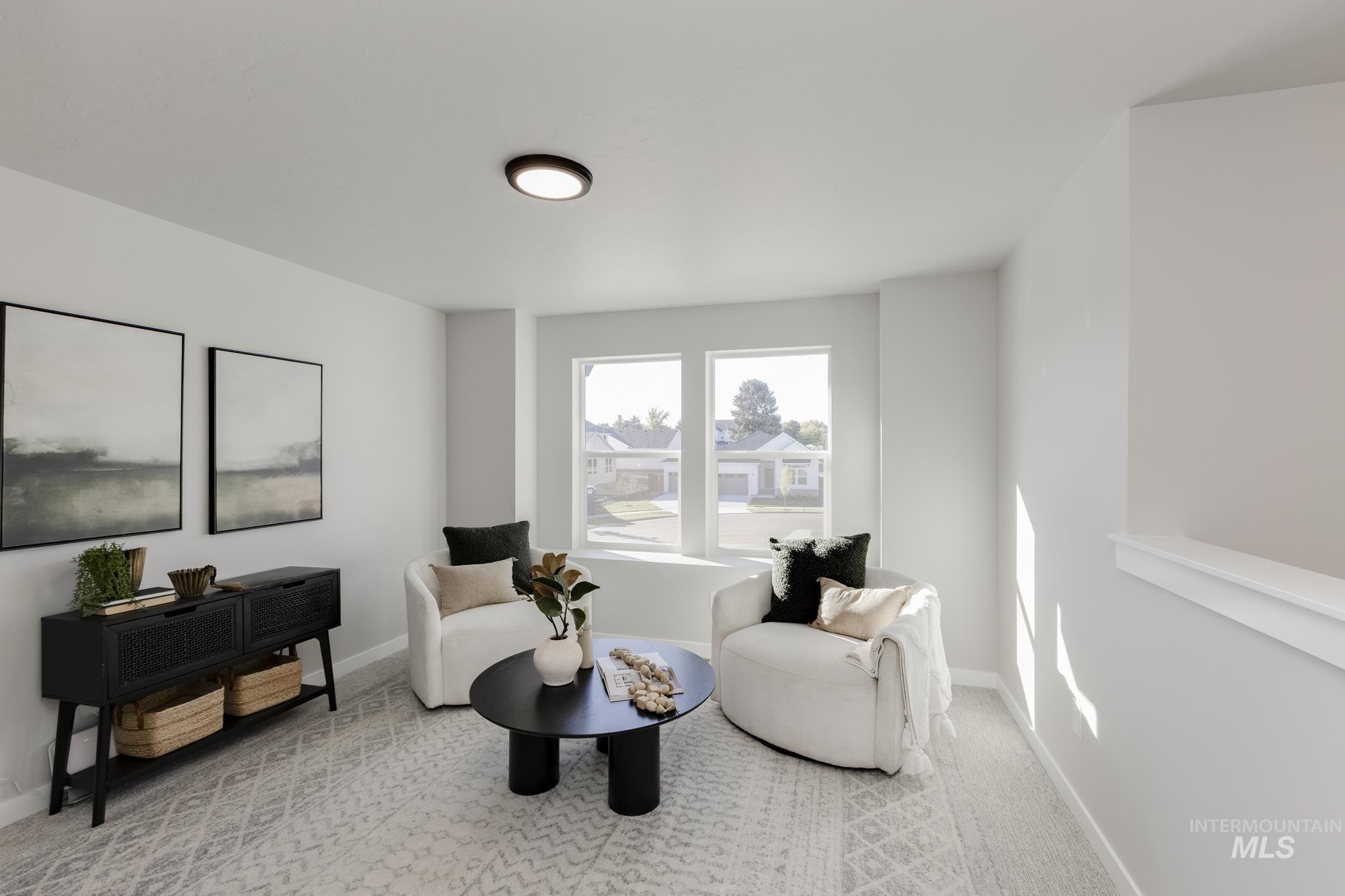 Sitting room featuring light carpet and baseboards