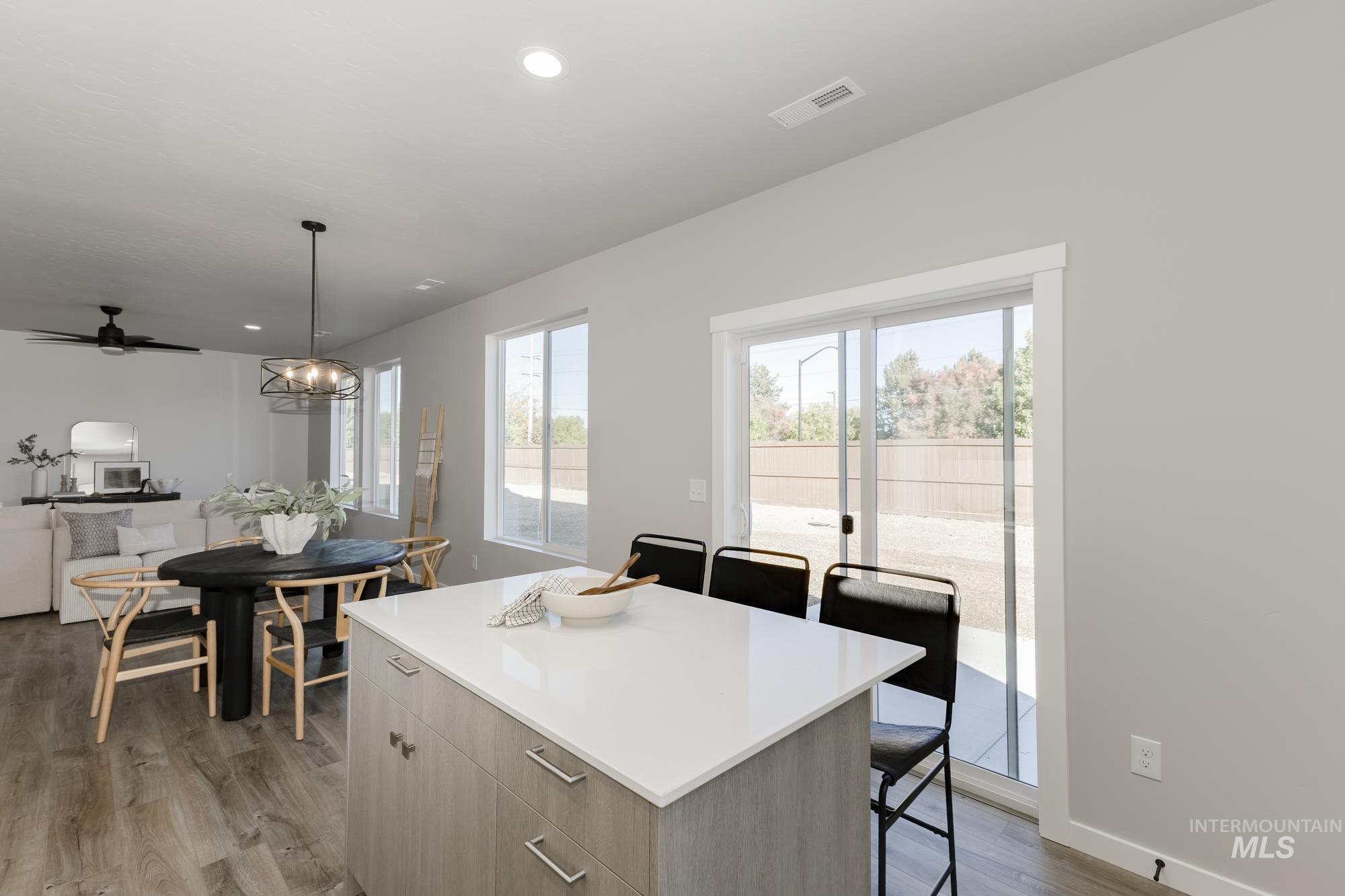 Kitchen featuring pendant lighting, a kitchen breakfast bar, plenty of natural light, modern cabinets, and recessed lighting
