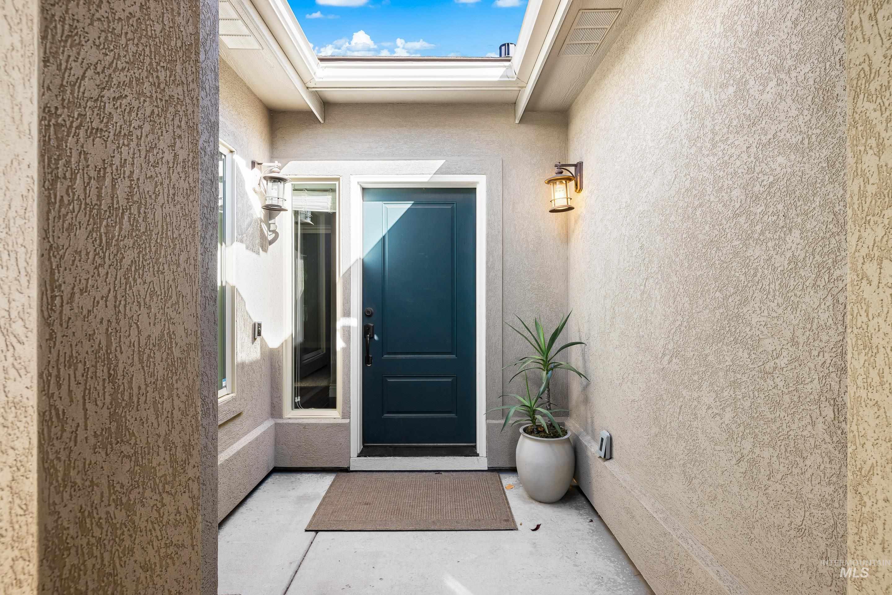 View of exterior entry featuring stucco siding