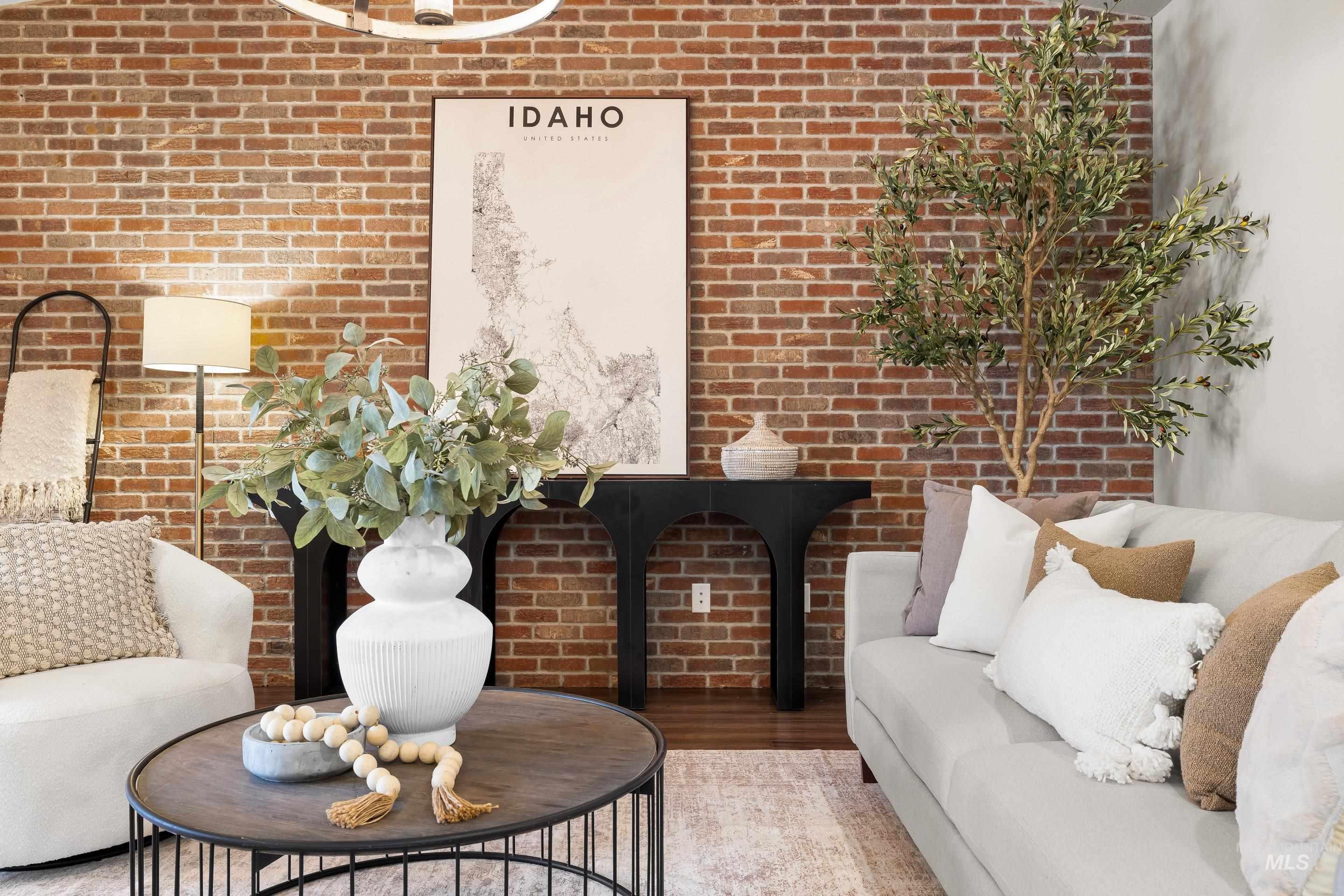 Living room with brick wall and wood finished floors