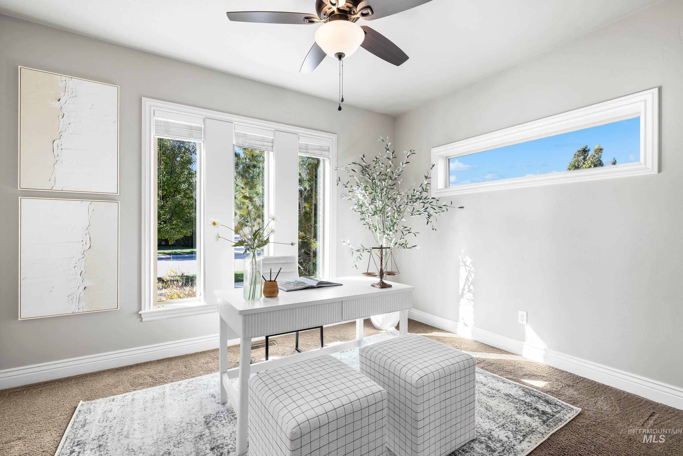 Home office with carpet and a ceiling fan