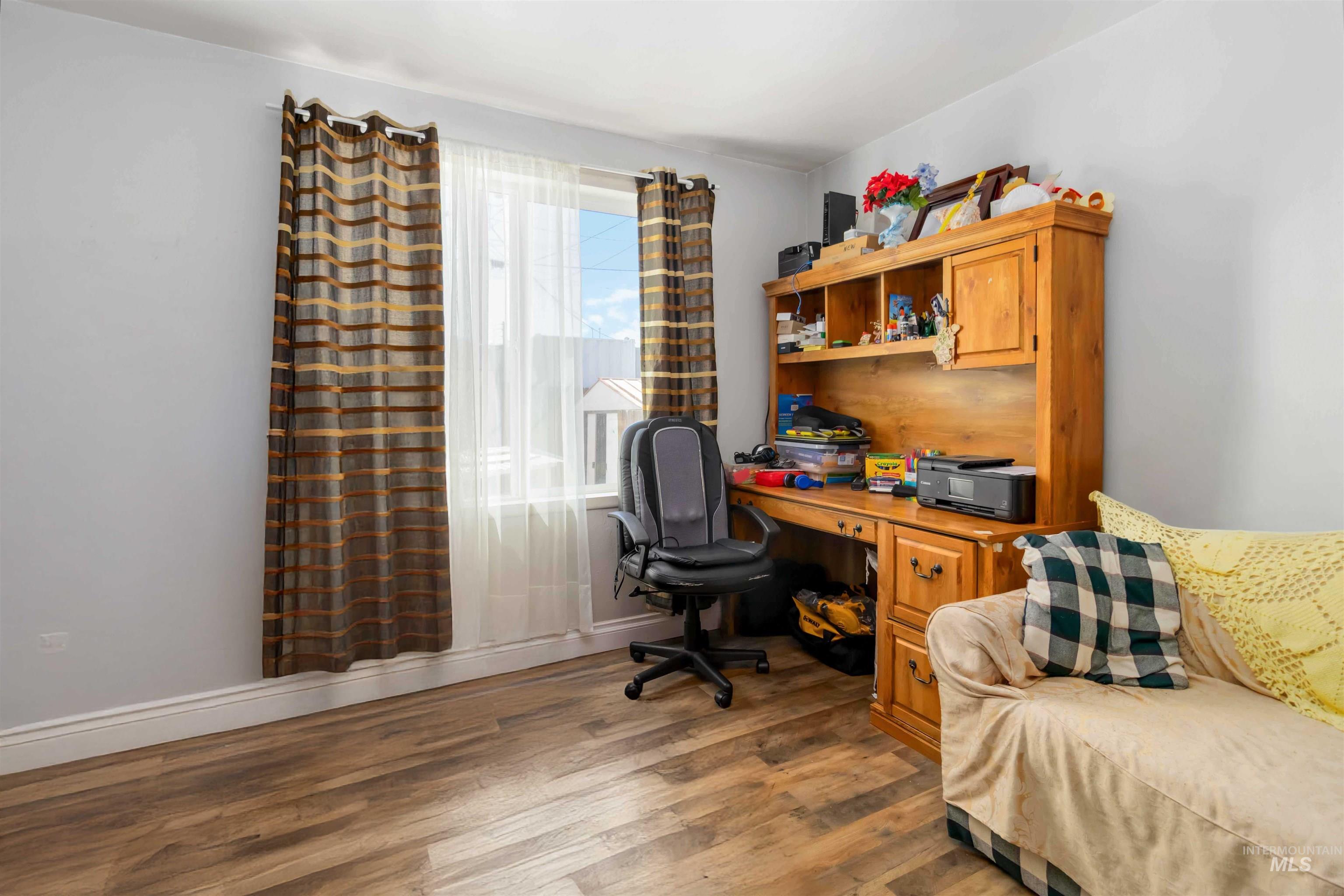 Office space featuring wood finished floors and baseboards