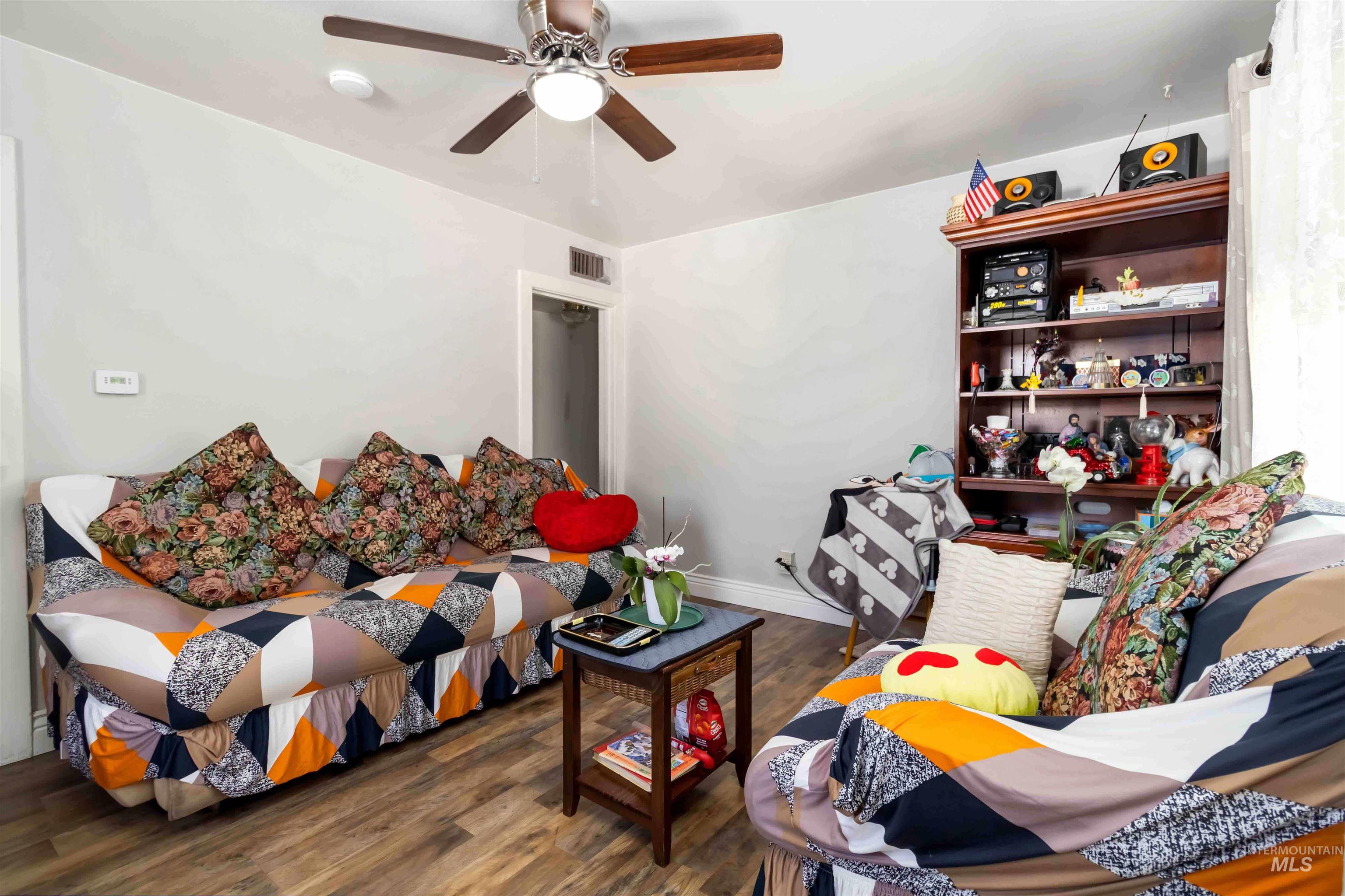 Living room with wood finished floors and ceiling fan