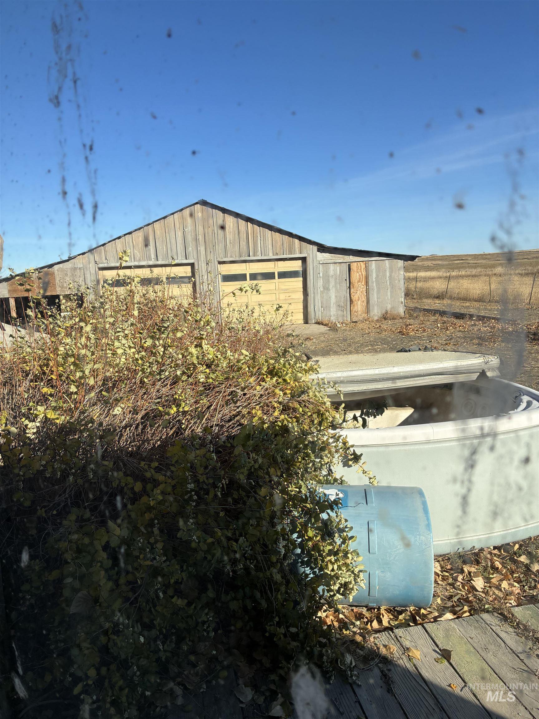View of property exterior with an outbuilding and a garage