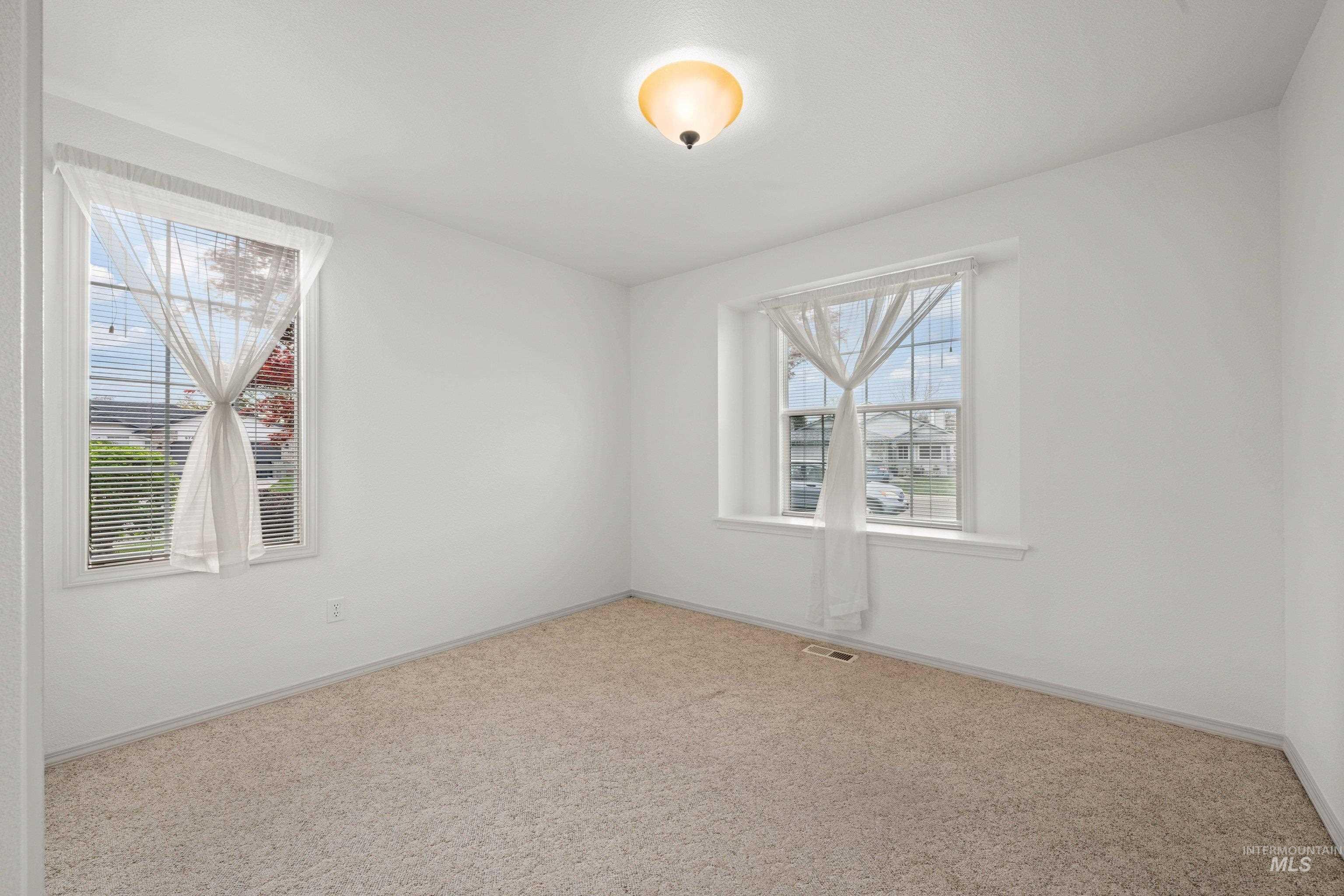 Unfurnished room featuring carpet floors and baseboards