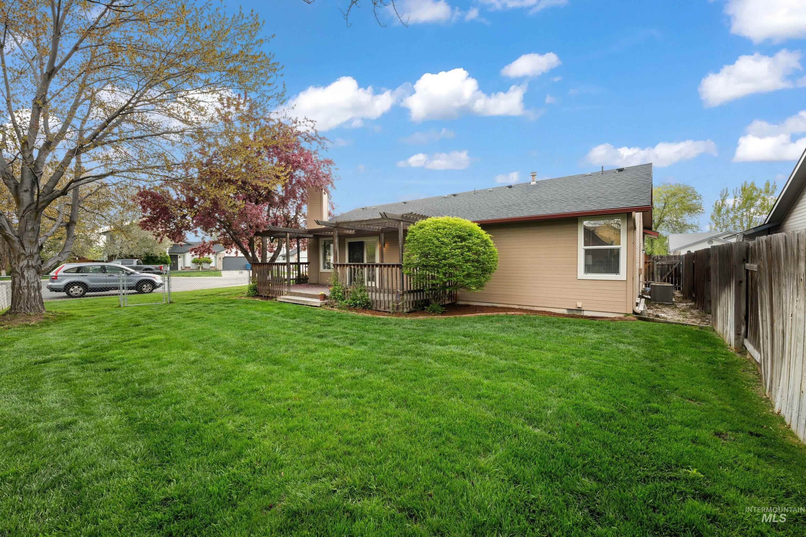 Back of property featuring a shingled roof