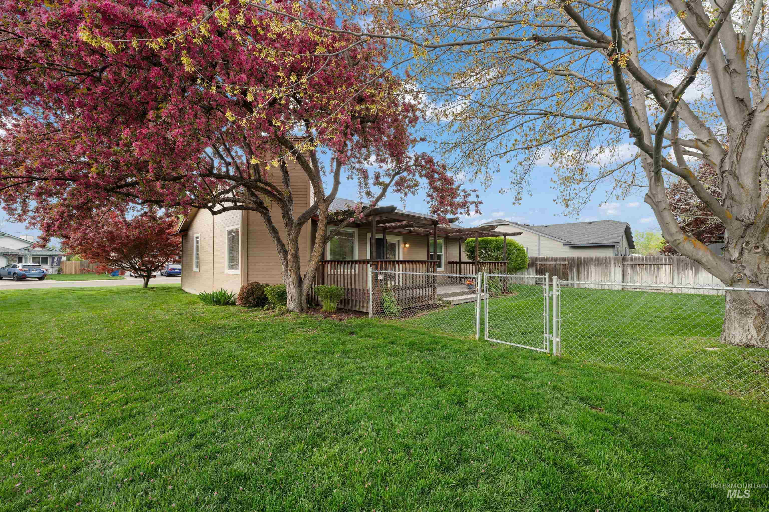Fenced yard featuring a gate and a wooden deck
