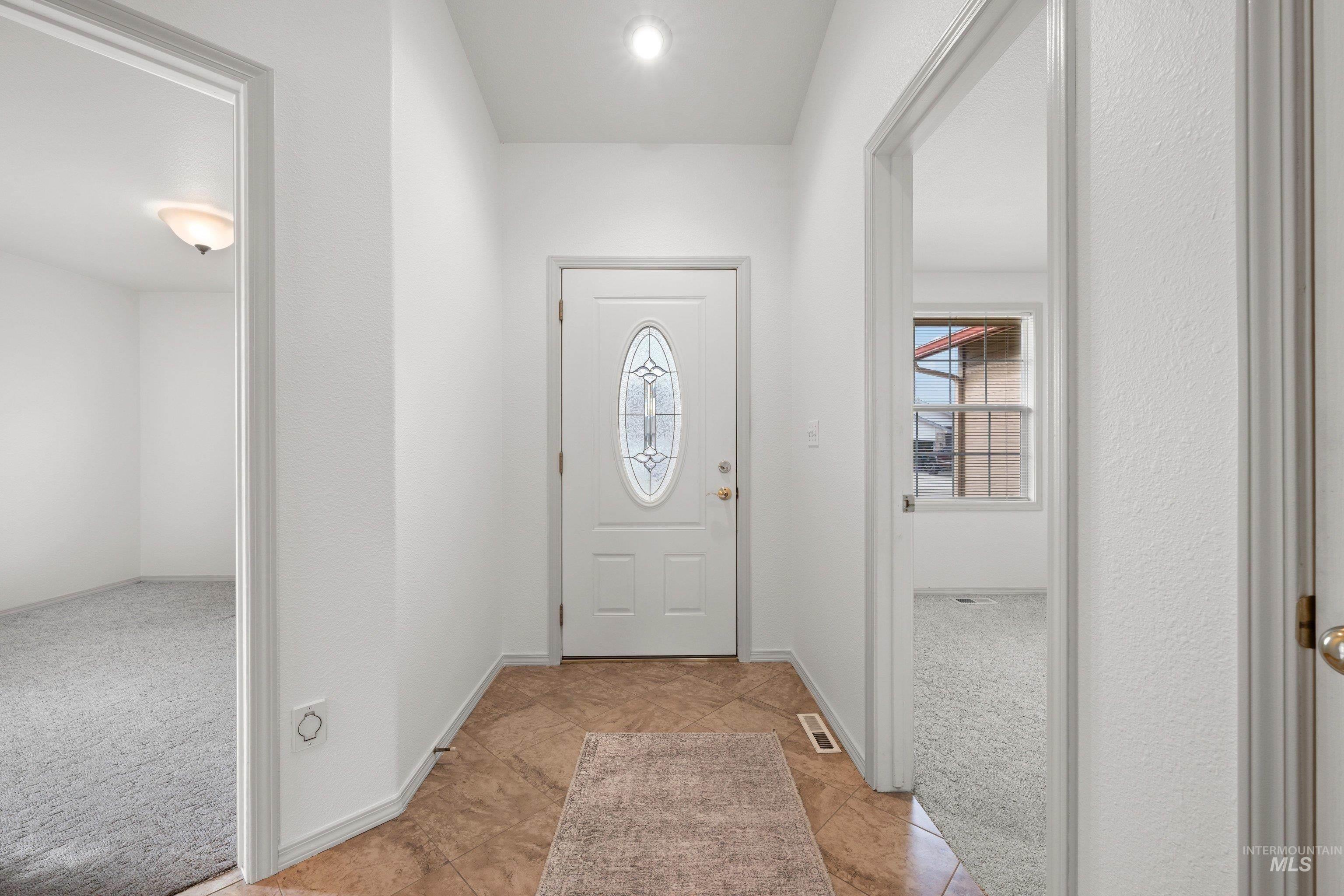 Foyer entrance with light colored carpet