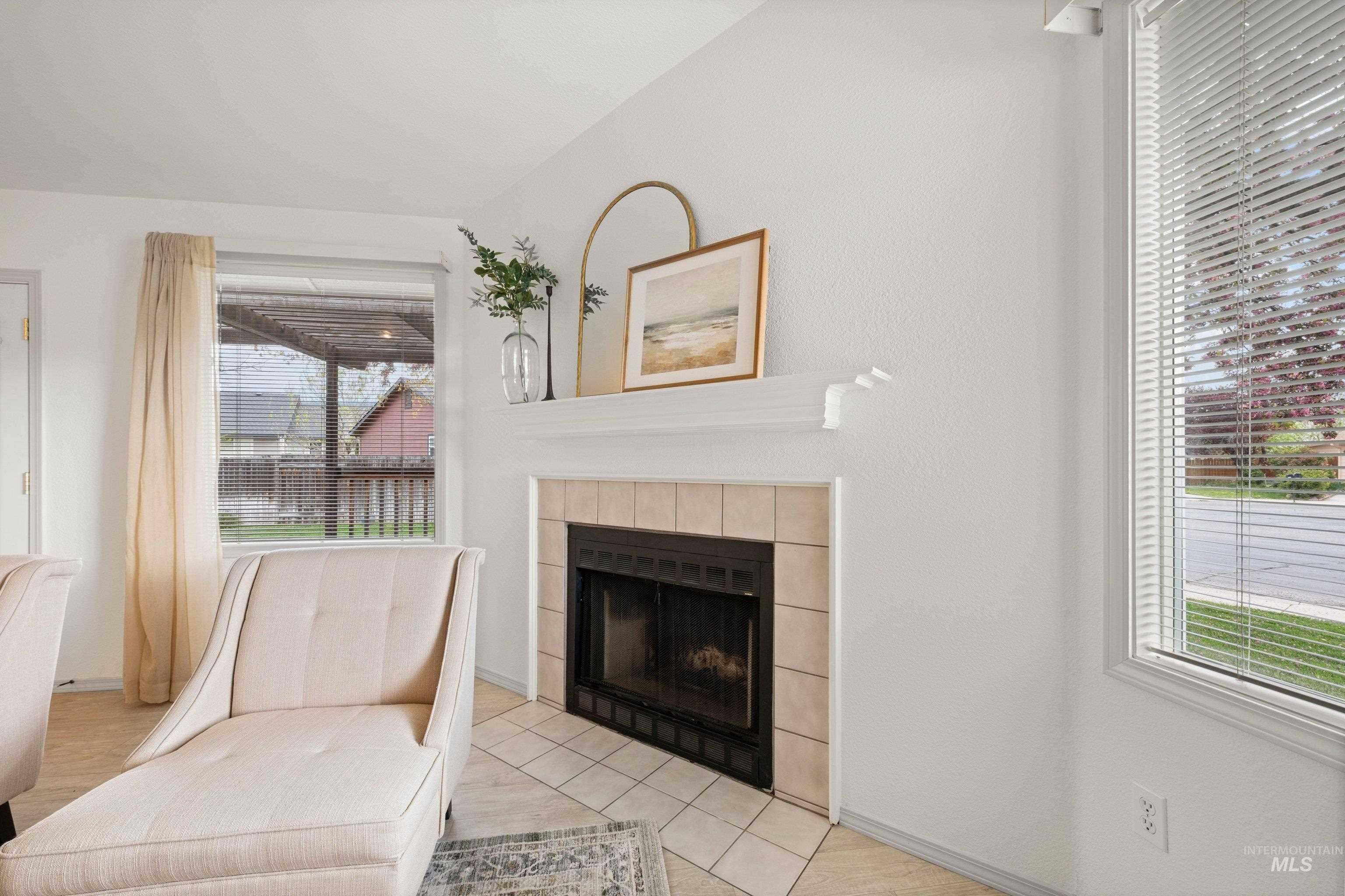 Unfurnished room featuring a fireplace and baseboards