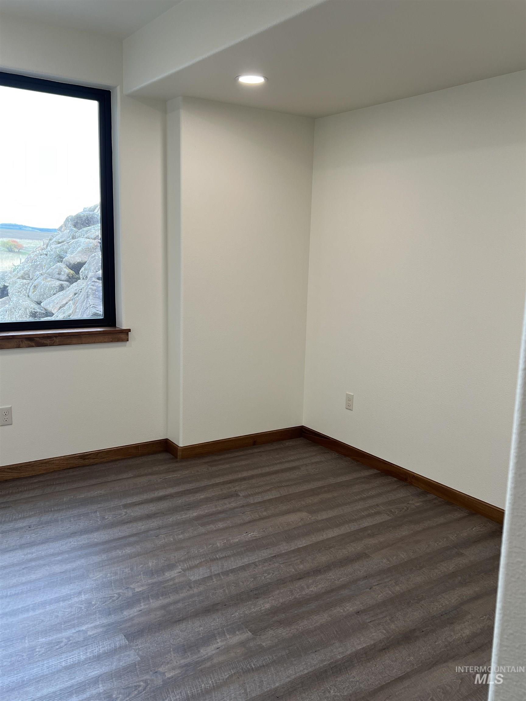 Spare room featuring dark wood finished floors and recessed lighting