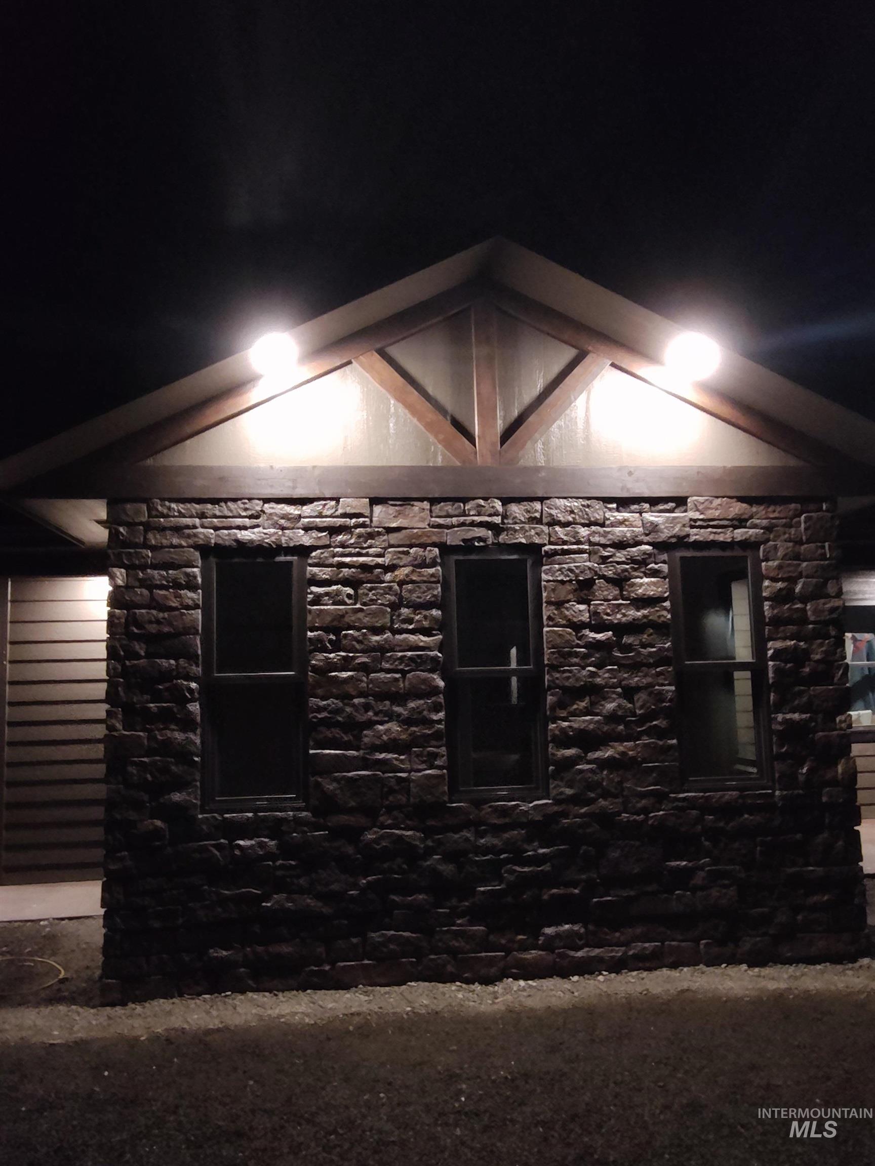 View of property exterior with stone siding