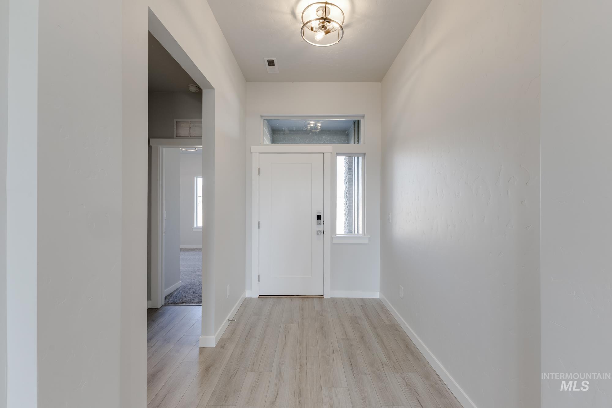 Entryway featuring light wood-type flooring and baseboards