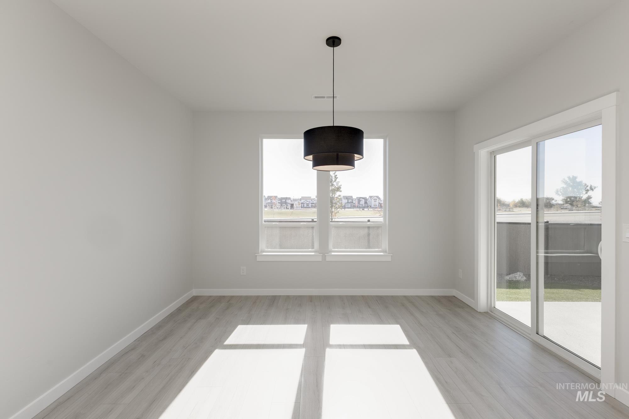 Unfurnished dining area featuring light wood finished floors